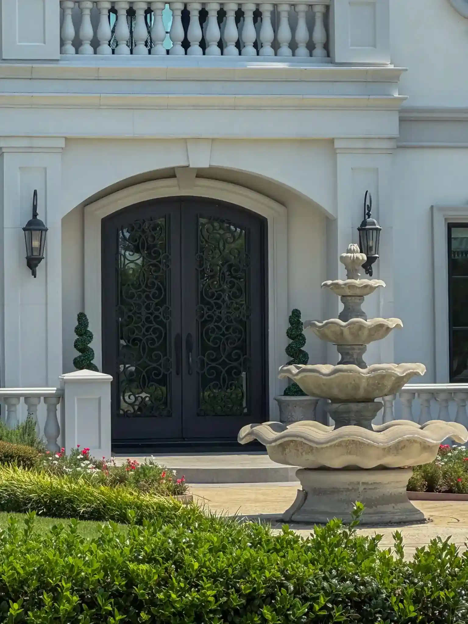 Traditional wrought iron door with a foundation and greenery on a Dallas-Fort Worth home