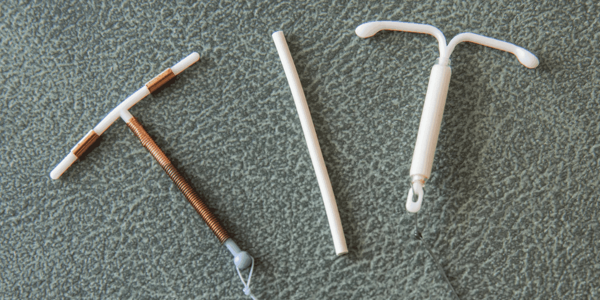 Close-up of different long-acting reversible contraceptives, including IUDs and an implant, used for family planning at Venus Women's Health.