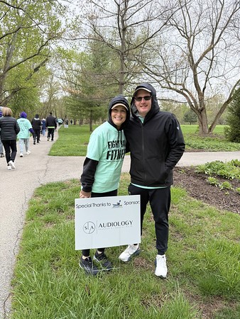 A smiling healthcare professional talks to a cheerful patient in a clinic setting.
