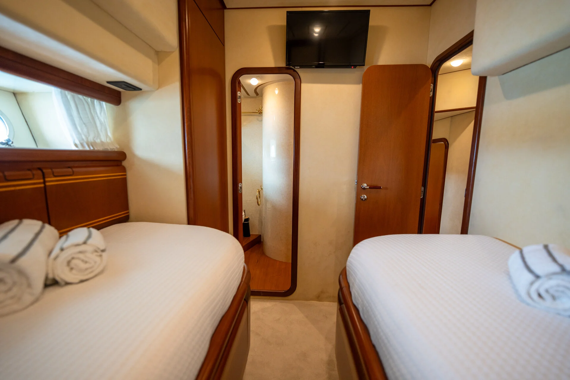 White Rock 36 speedboat with captain at helm cruising calm blue waters near Paros coastline with hills in background.