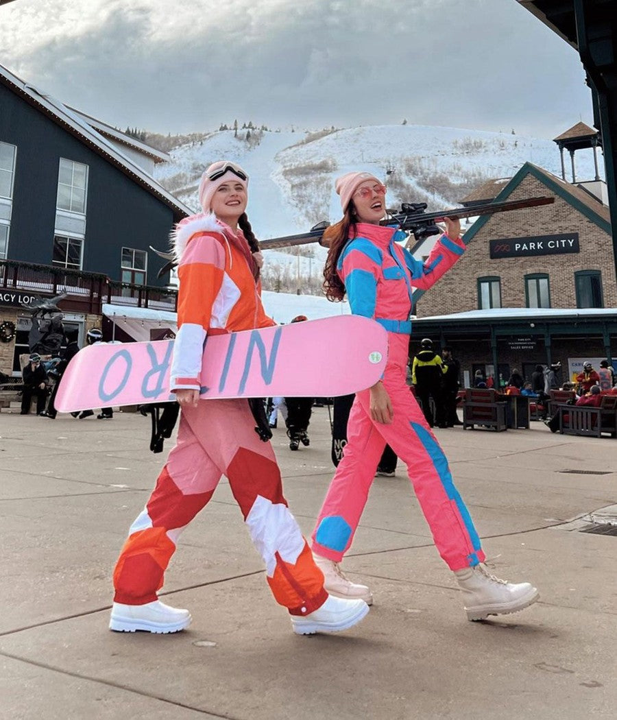 Two people in colorful ski outfits at Park City