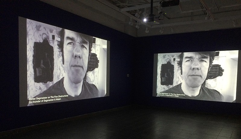 a projection on the wall with a man in a black and white image