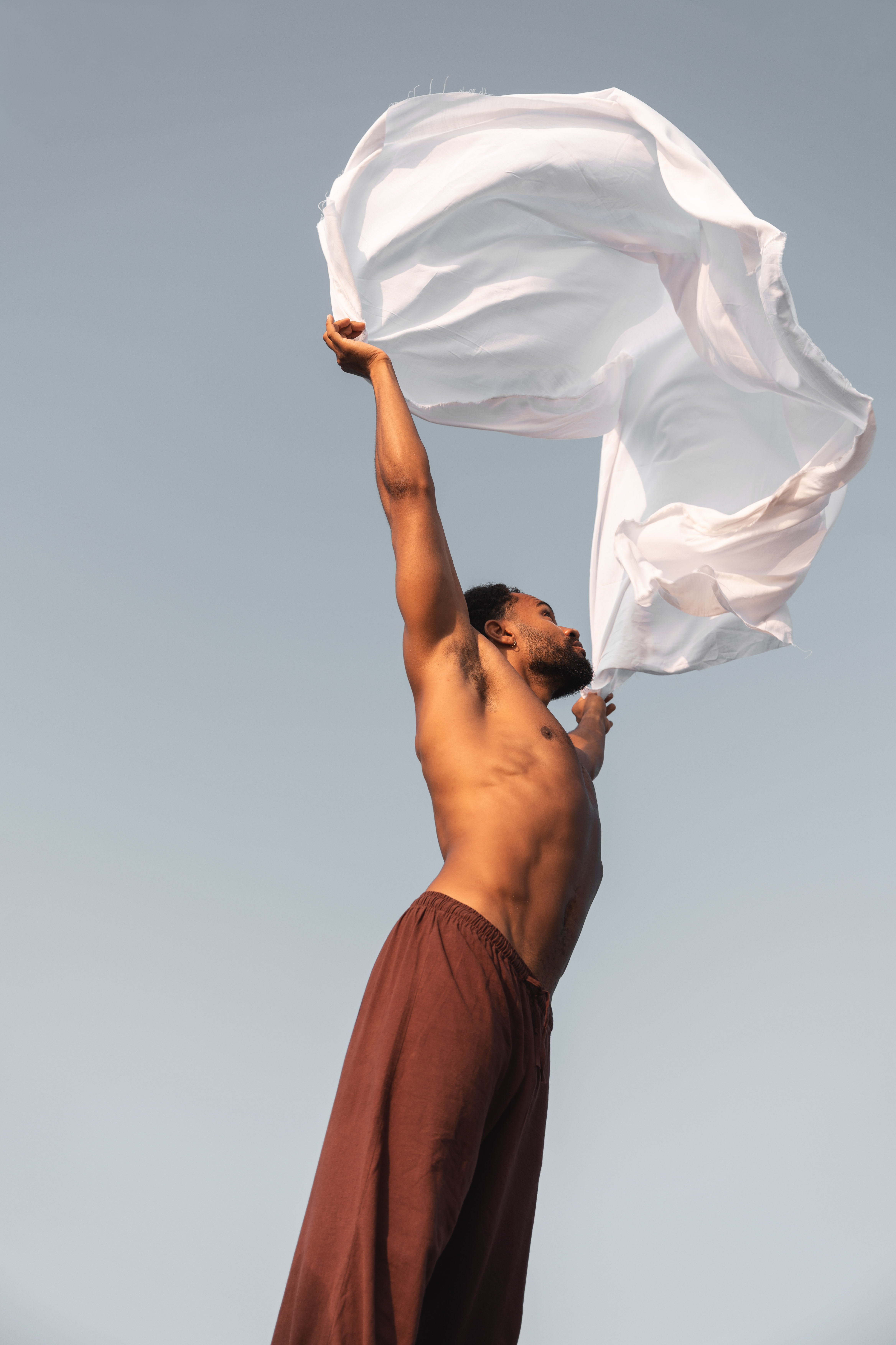 A girl holding her head in both hands looking to the side
