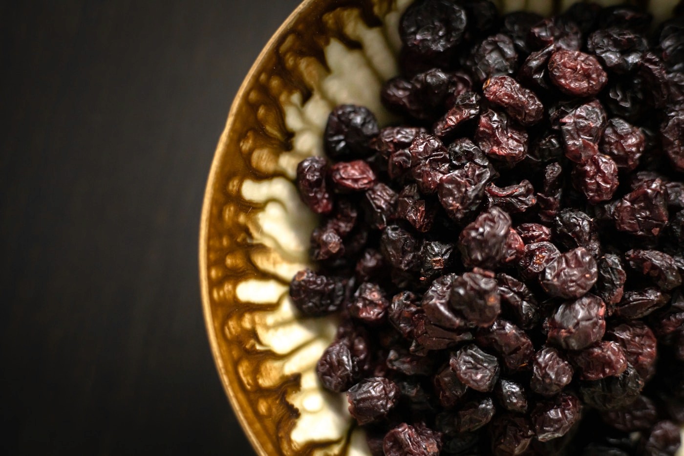 A plate of dried prunes, one of the most reliable fiber and sorbitol-rich foods for constipation relief