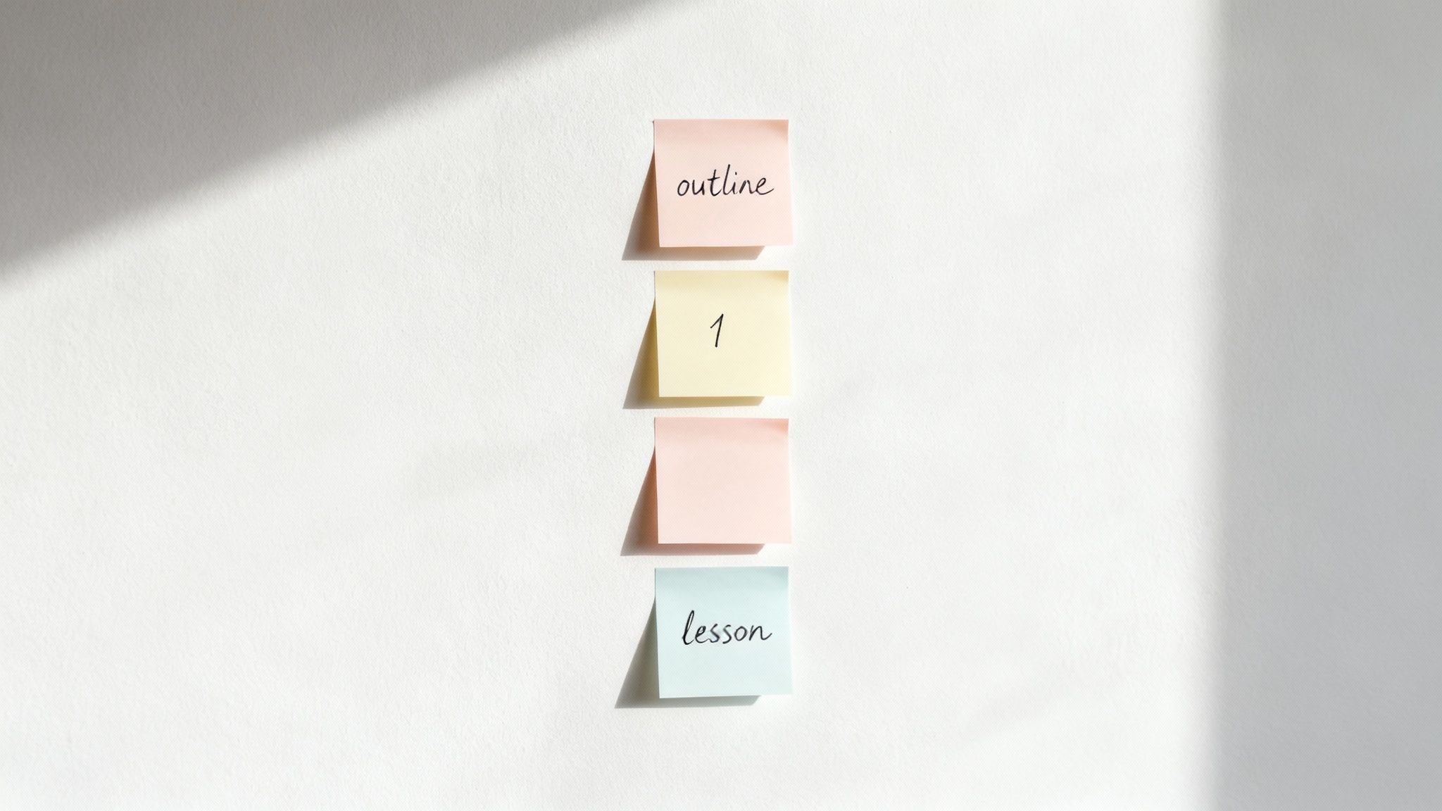 A person at a desk breaking down a large project on a whiteboard into smaller, manageable sticky notes.