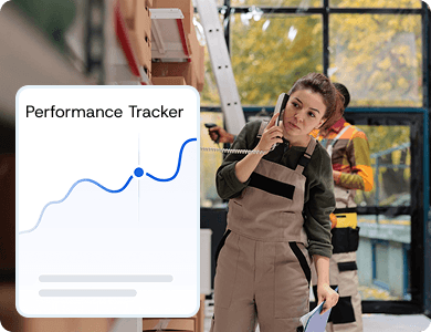 Female contractor using a tablet with a digital “Performance Tracker” graph overlay, representing compliance and real-time audit visibility.