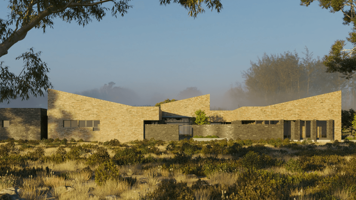 Golden hour sunset light falls on modern brick design with grass in the foreground