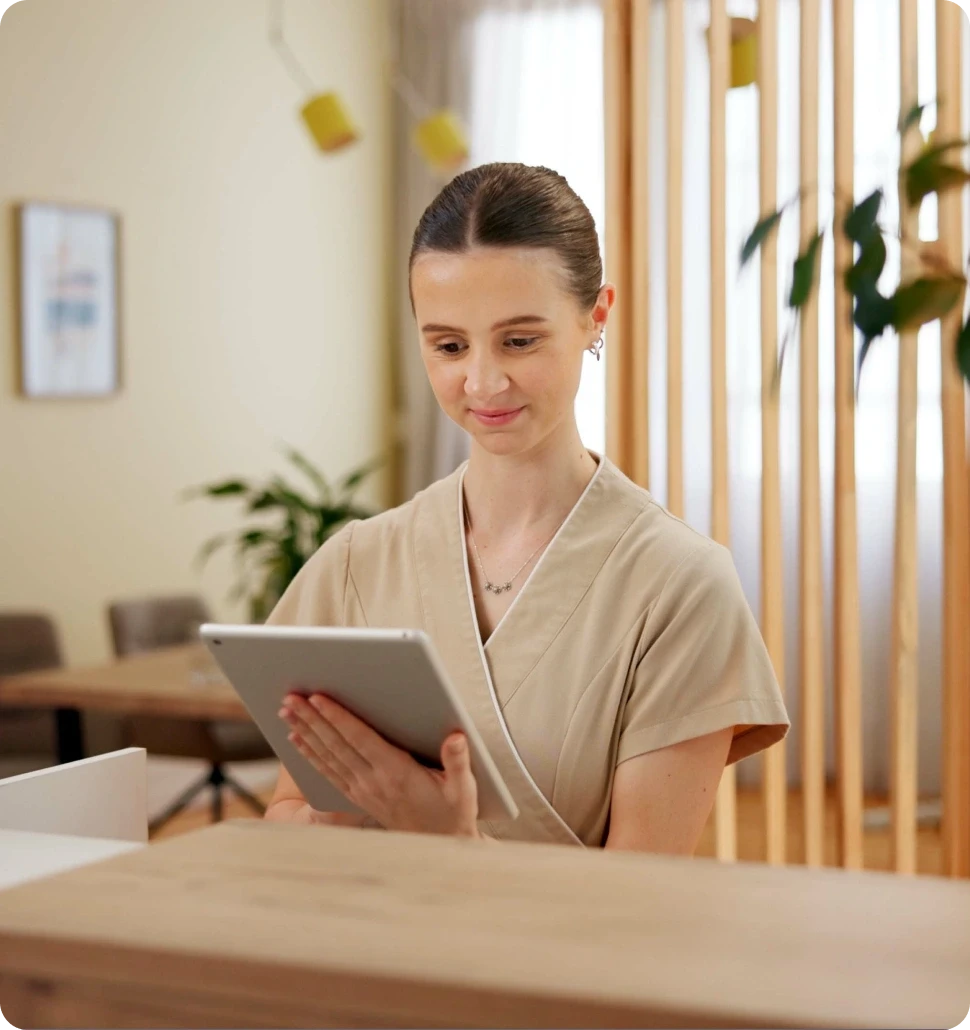 A dark cylindrical object on a wooden bar, with softly glowing lights in the blurred background.