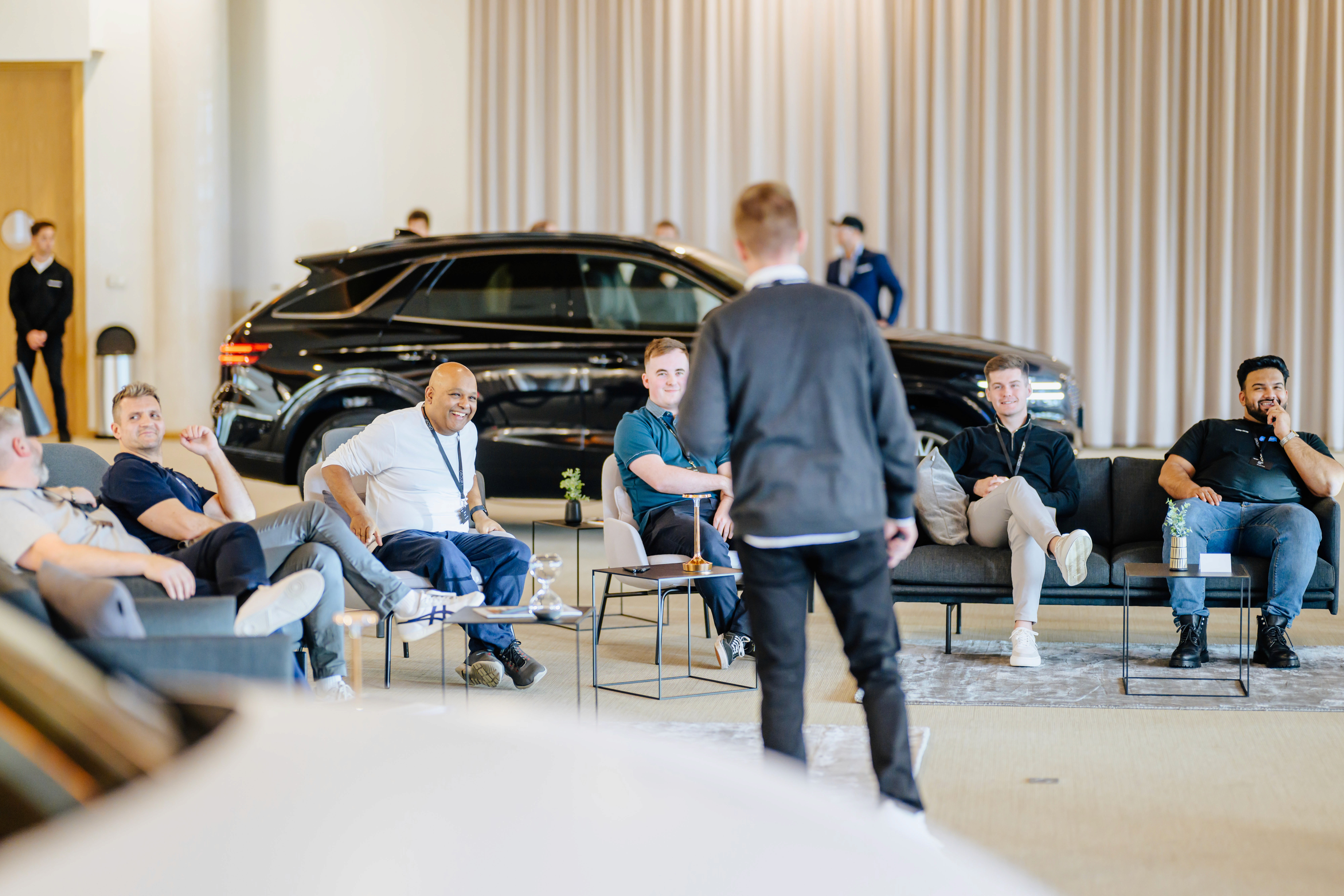 Product presentation inside the Genesis vehicle – an expert conversation during an exclusive automotive event.