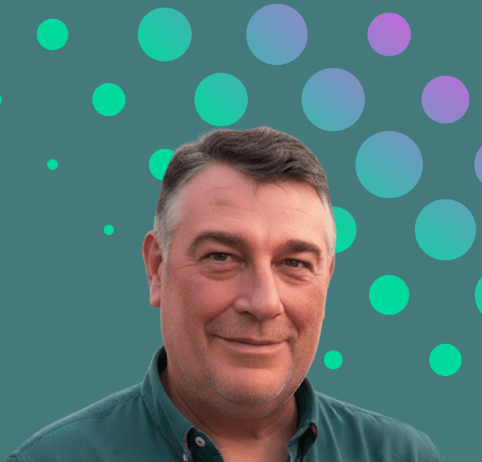 Portrait of a man in a dark green shirt against a teal background with colorful circles.