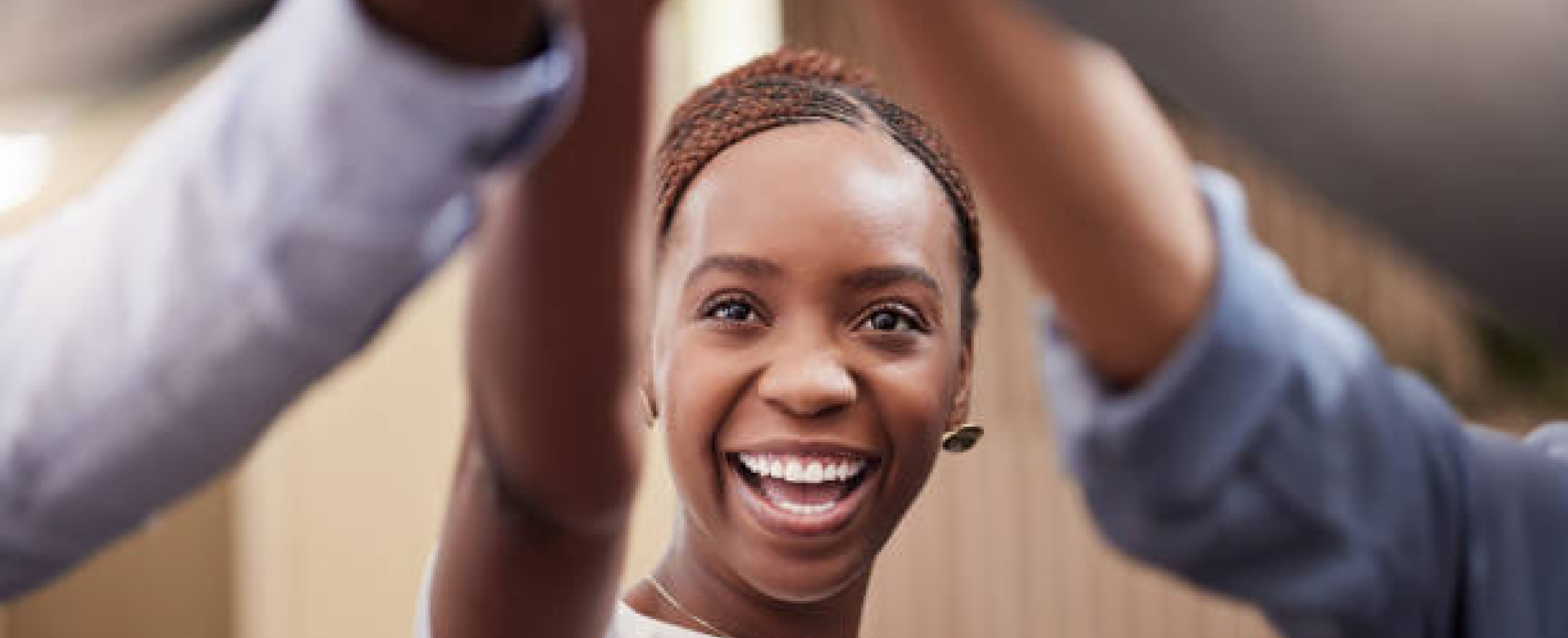 a lady smiling while puttin her hand up for a group high five