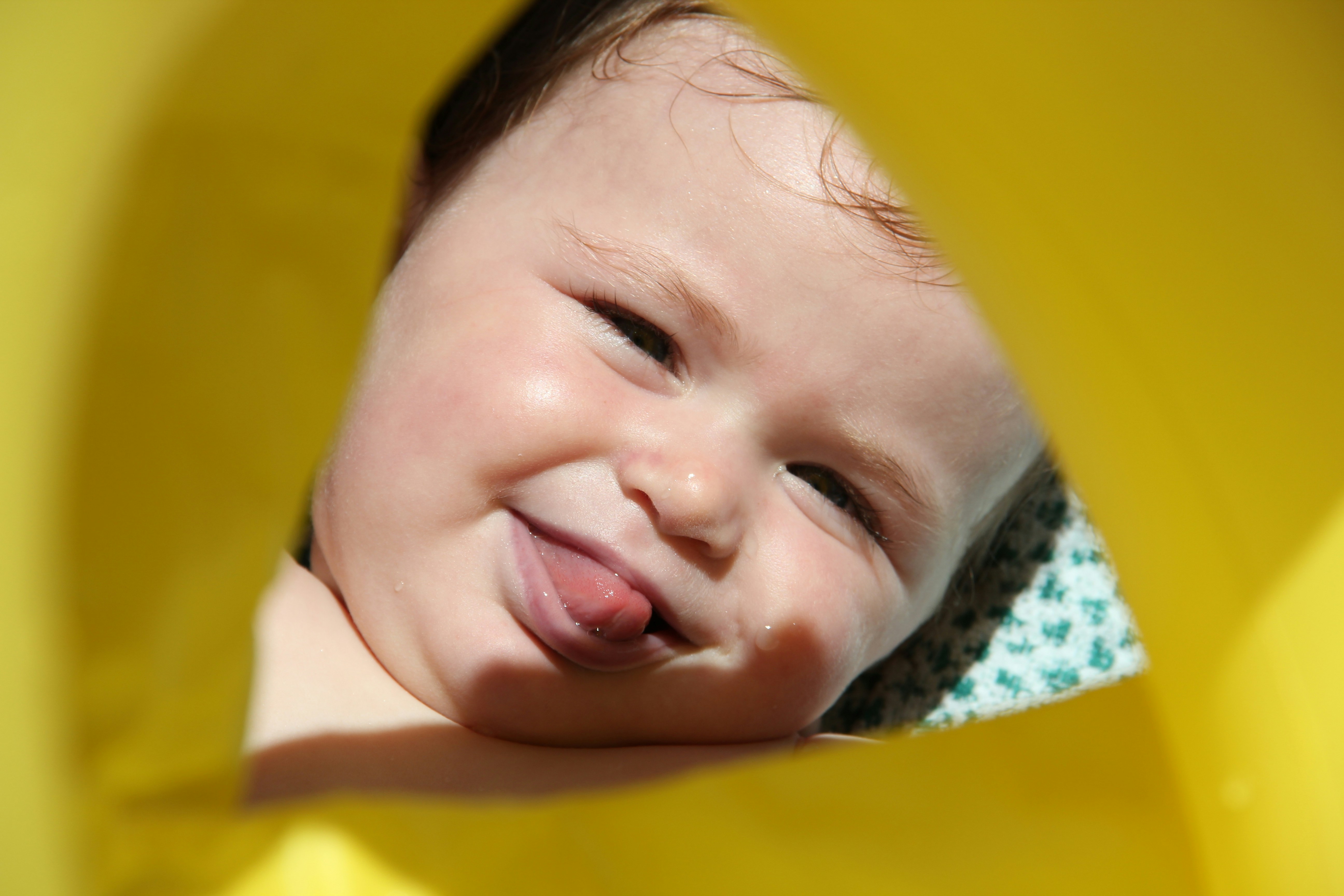 smiling baby in yellow shirt