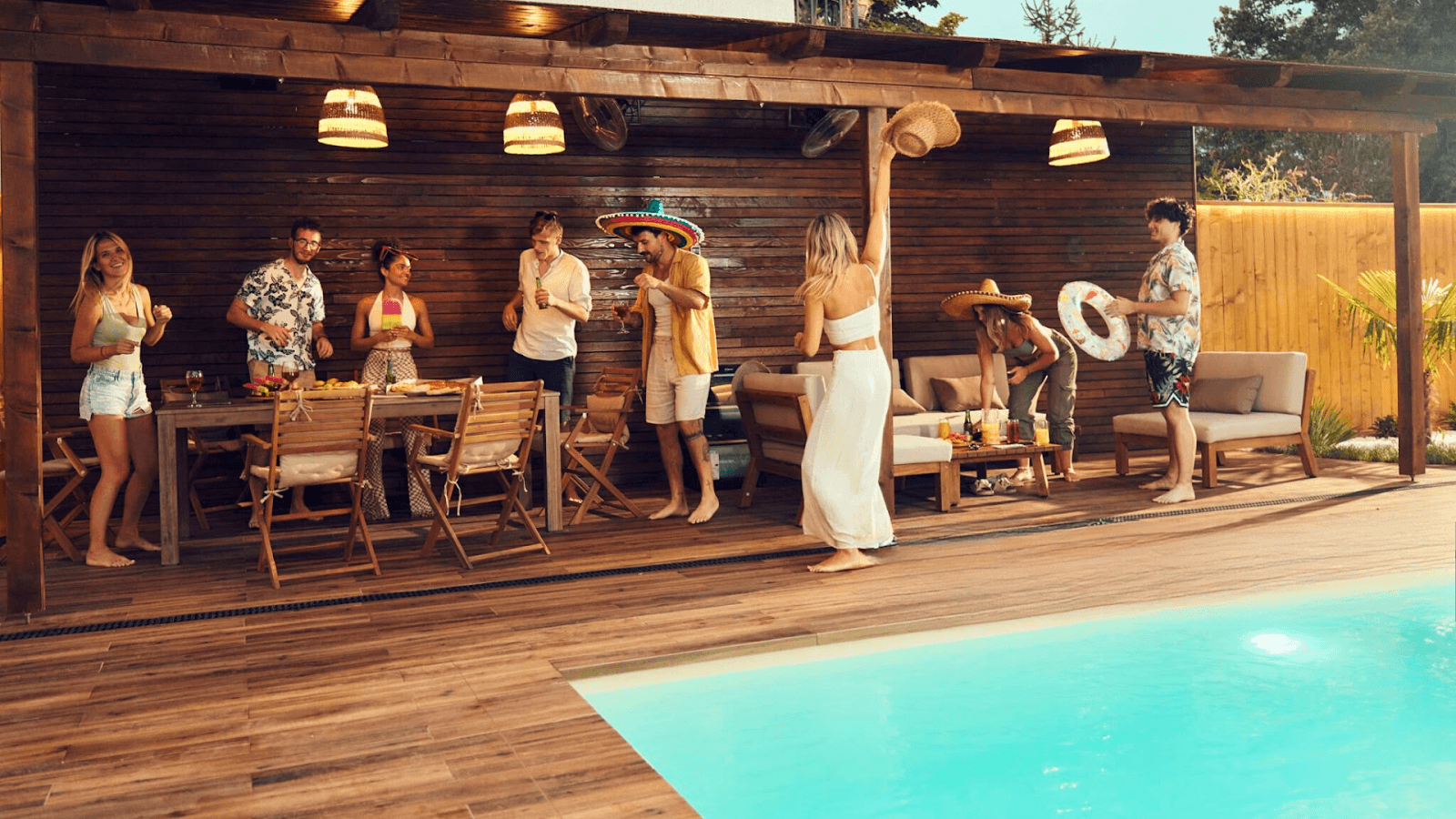 Family relaxing by a smart pool, using an app to adjust temperature and lighting for a perfect evening.