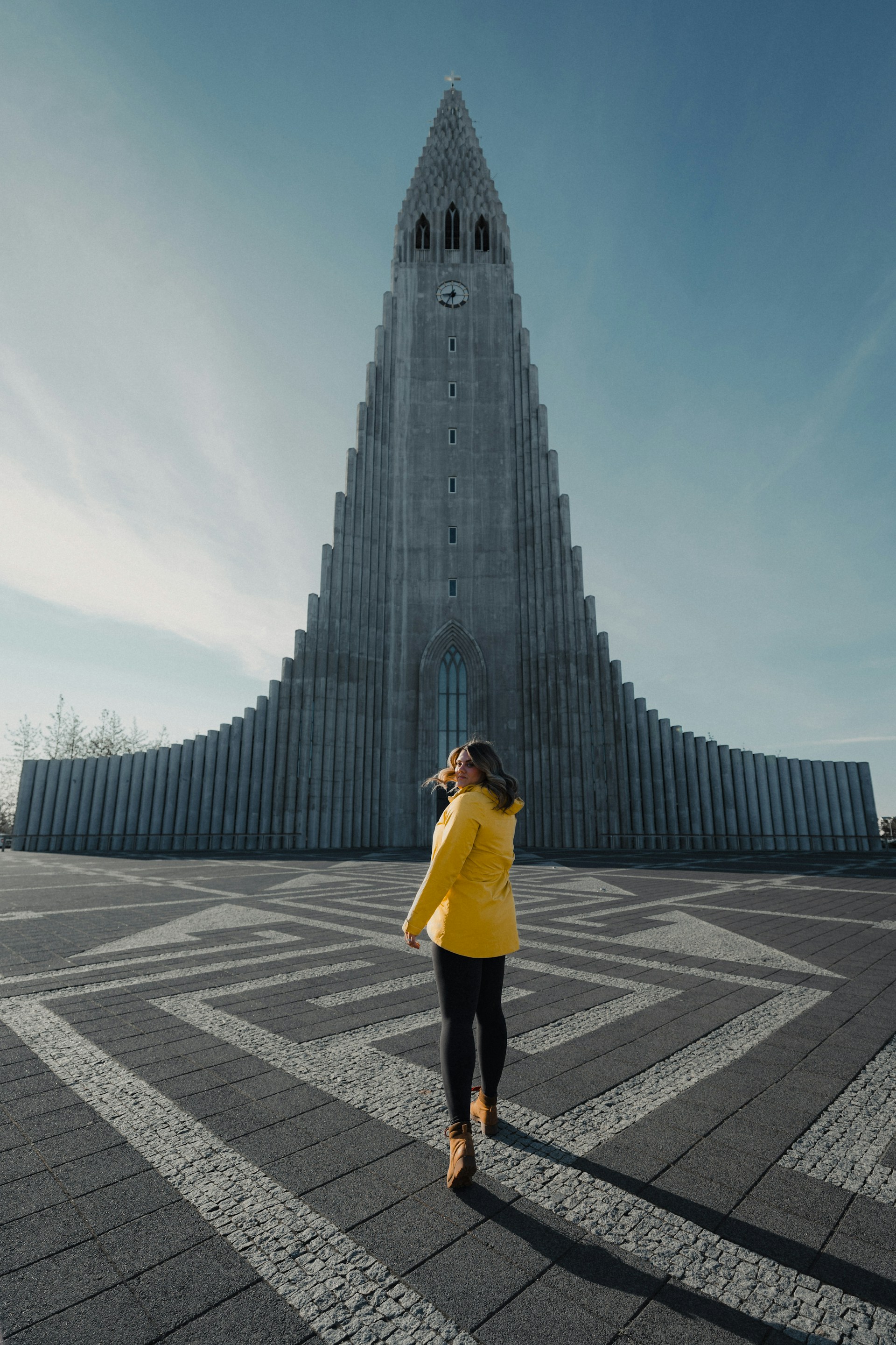 woman tourist in front of hallgrímskirkja in reykjavík