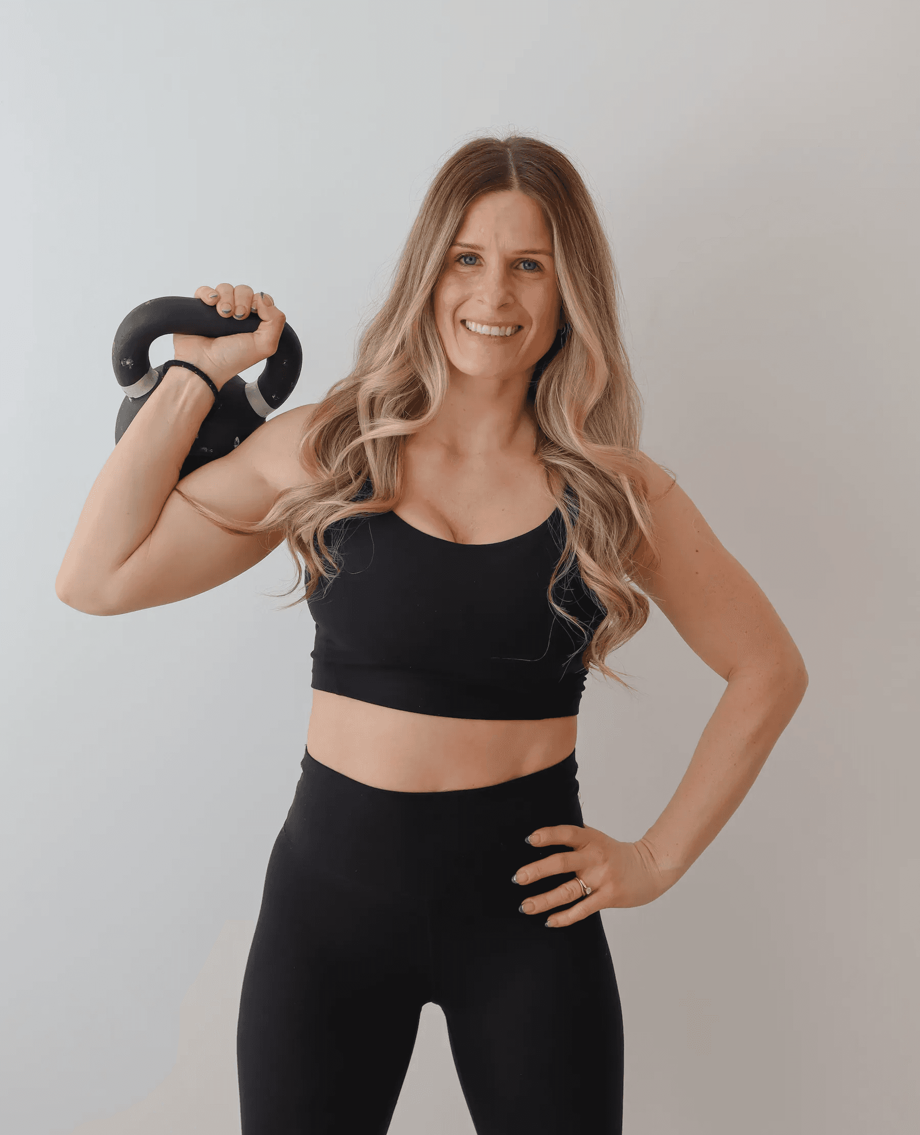 Alanna holding a kettlebell for a Rise Within Fitness strength and mobility class in Barrie