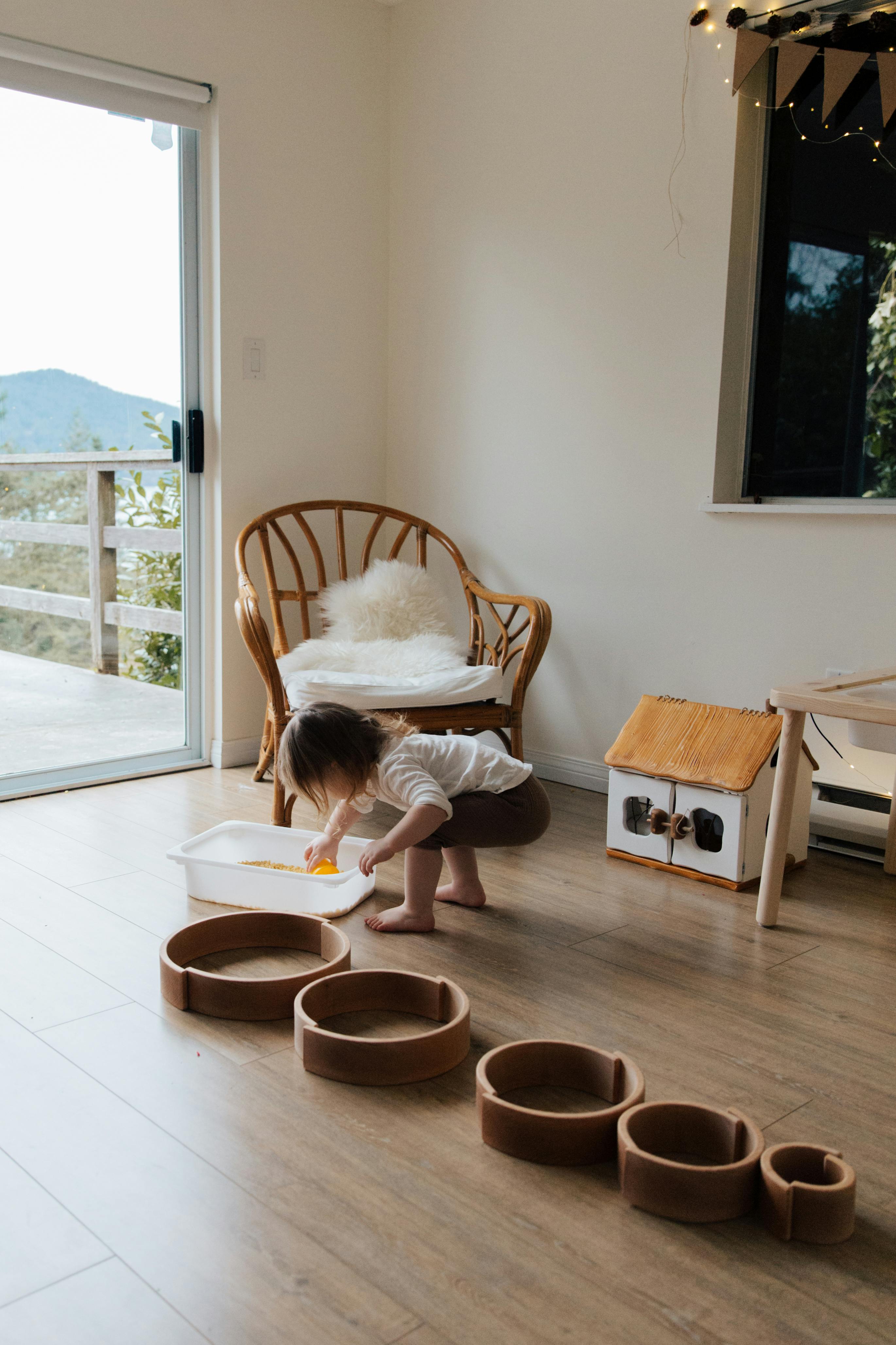 Child playing on water-resistant hybrid flooring in a Brisbane living space, where spills wipe away easily and the slip-resistant surface helps keep playtime safer.