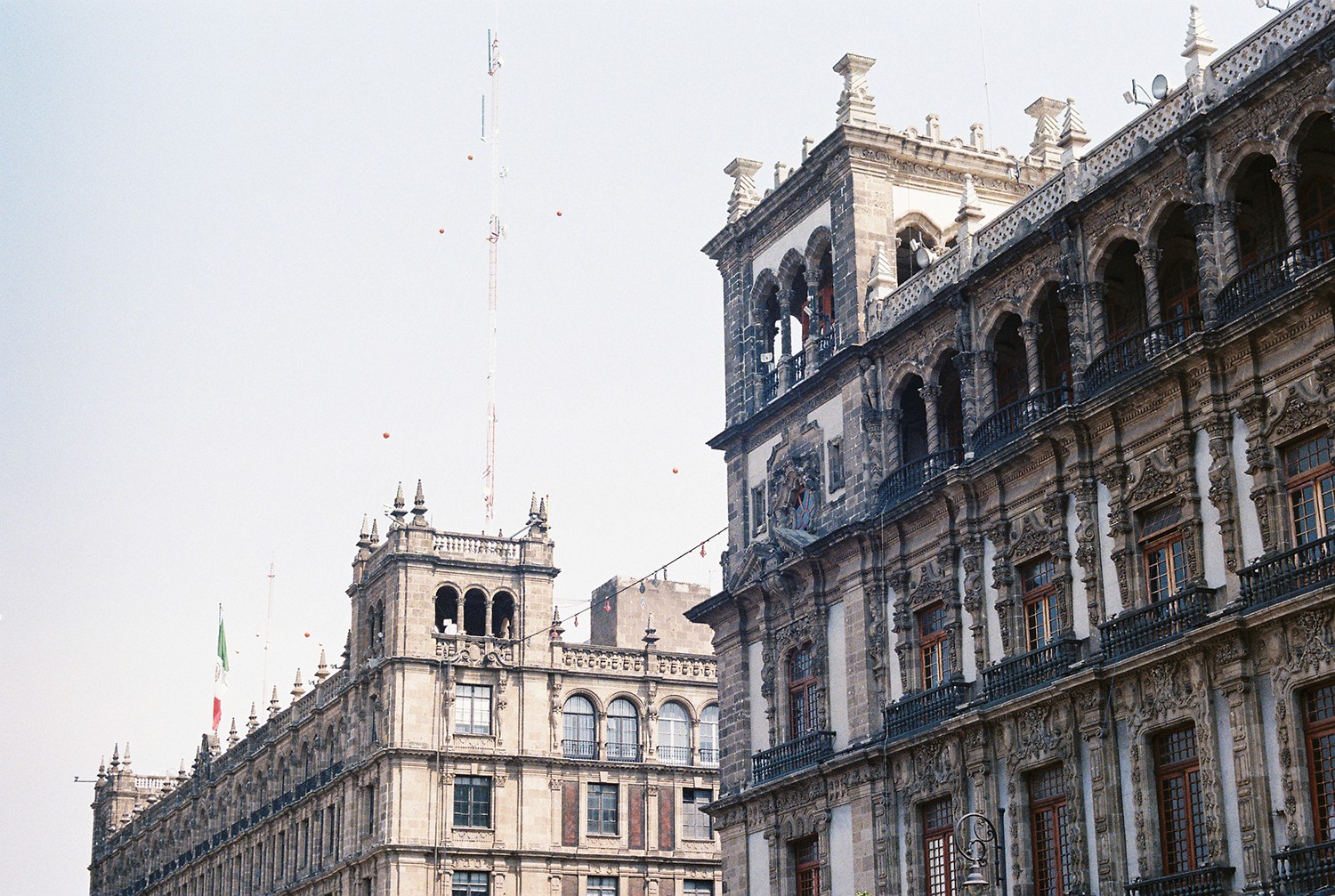 Four diverse professionals collaboratively working on a laptop, with one person pointing at the screen while others observe.