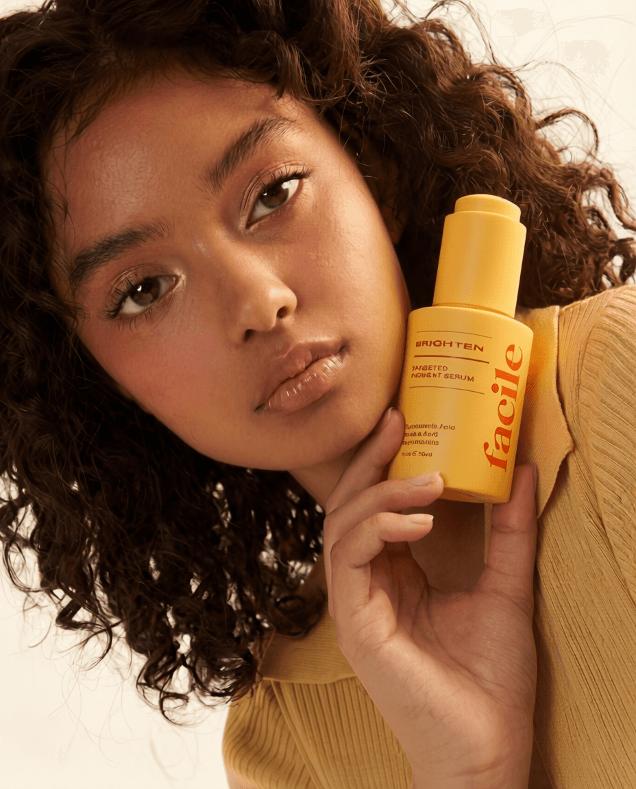 Young man leaning against wood post at sunset desert landscape.