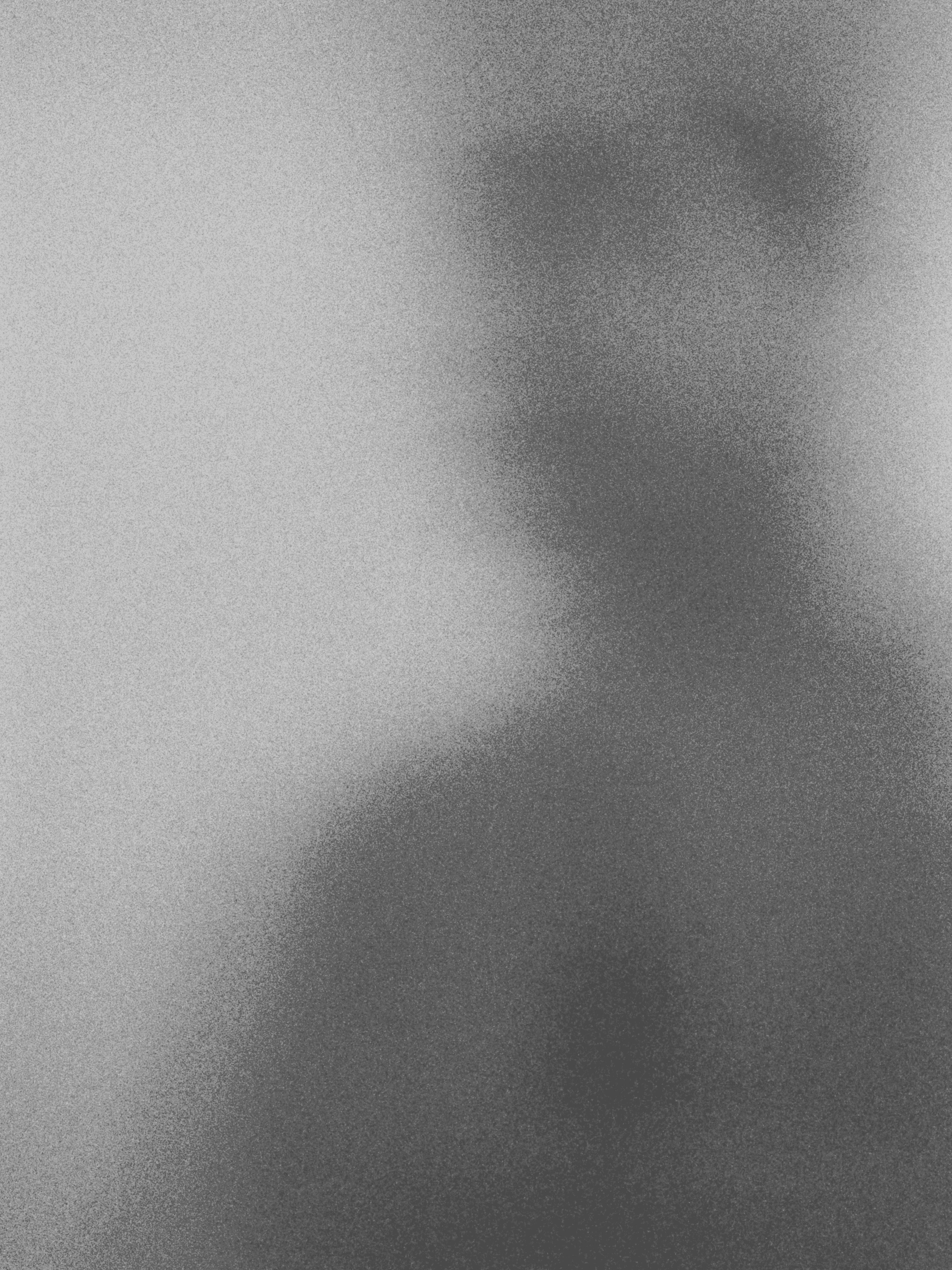 Blurred blue silhouette of a person wearing sunglasses.
