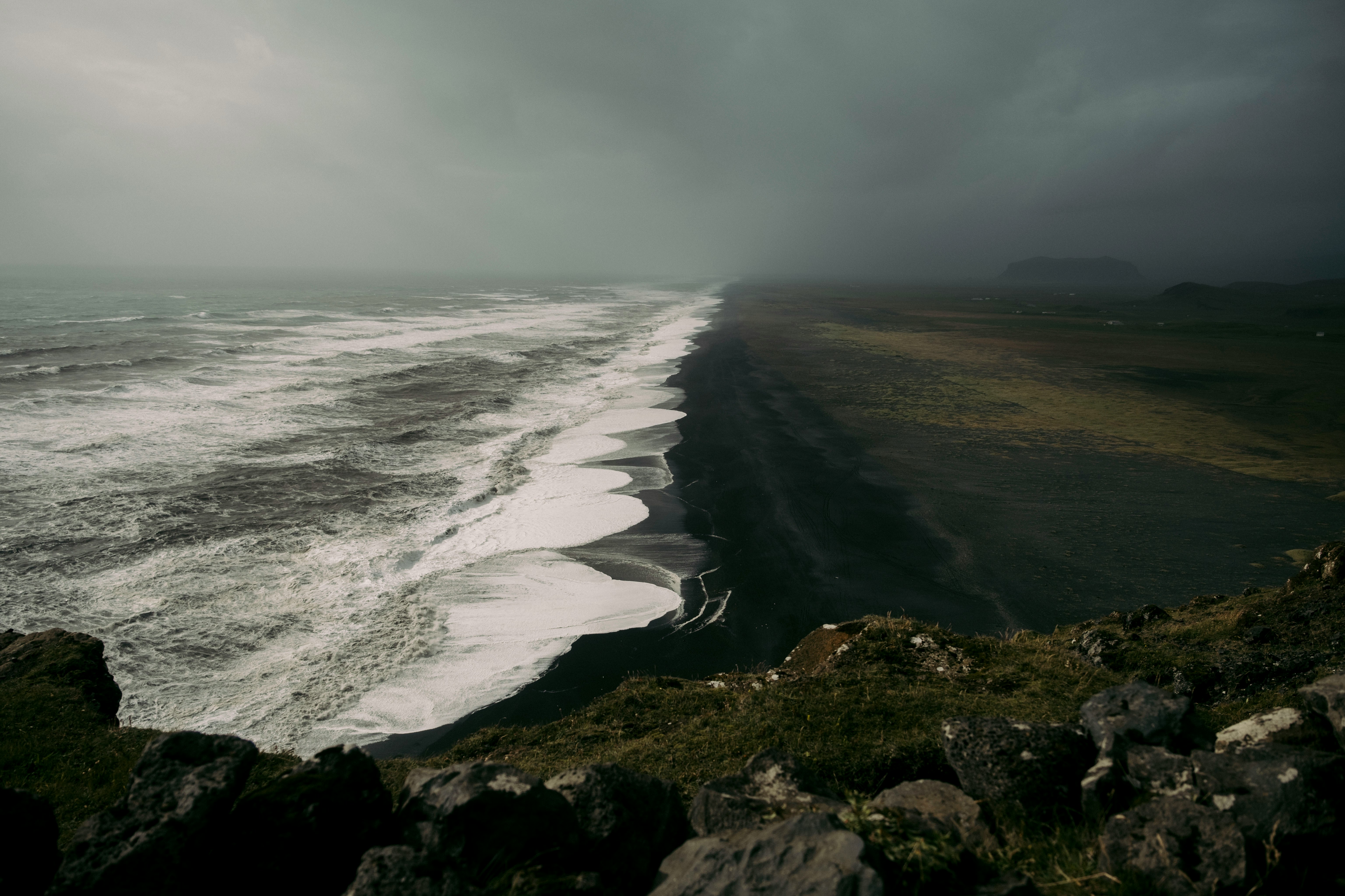 Waves crashing onto a black sand beach in Iceland.