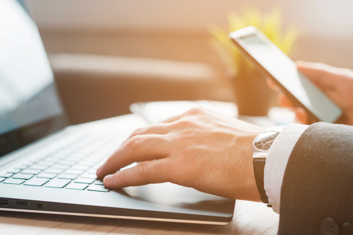 woman sitting around table holding tablet