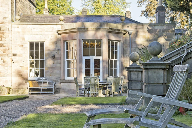 Hartingtons Heritage Tours hotel, Darley House, Garden lawn and wooden chairs