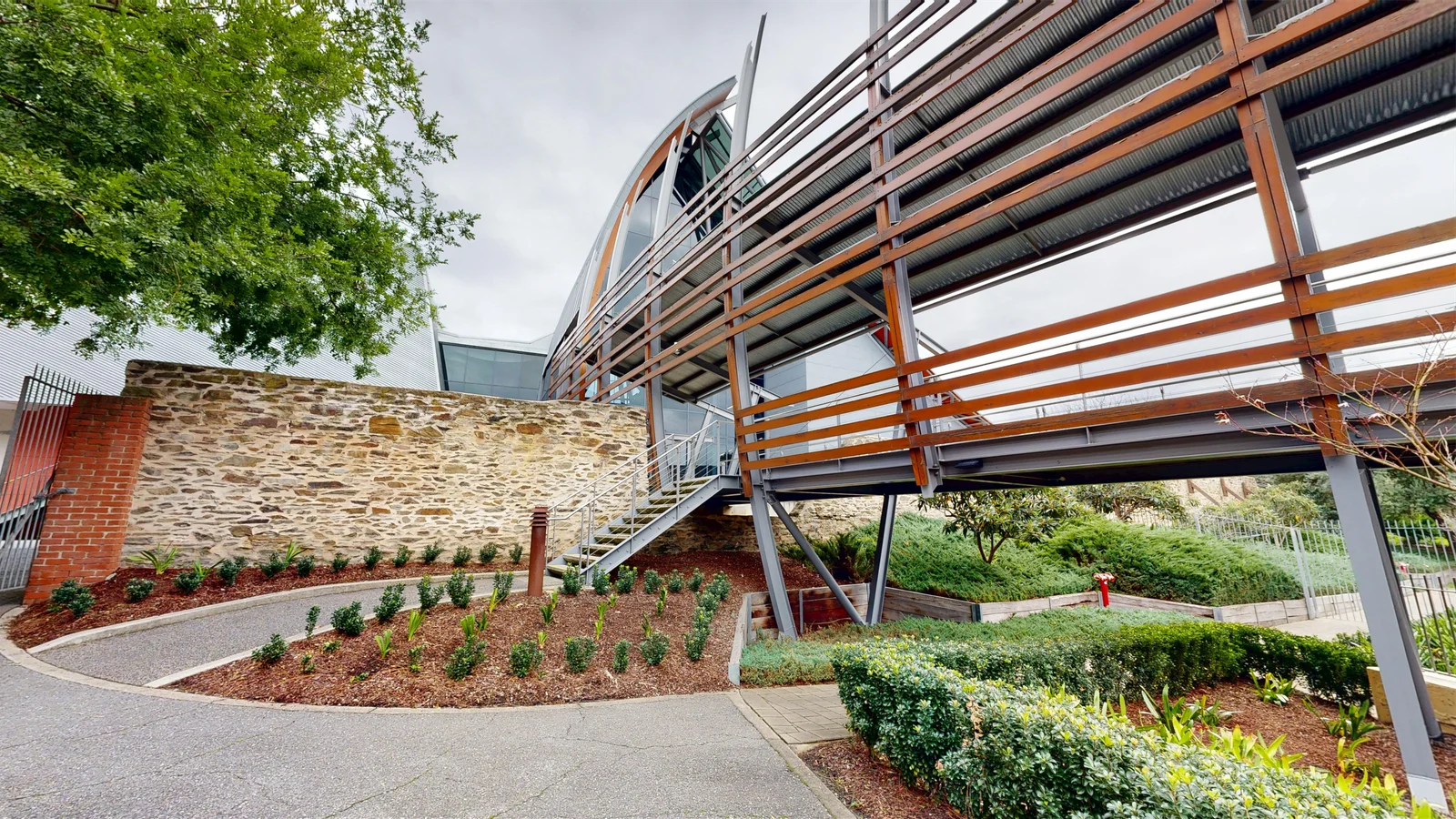 A high-fidelity 3D digital twin showcasing the complex architectural design and exterior facade of the National Wine Centre of Australia in Adelaide, captured by ABM visual.