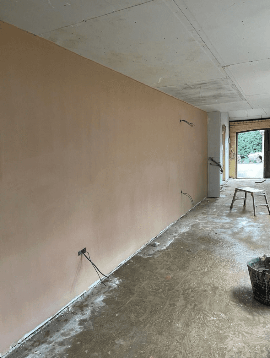 Freshly plastered wall with a smooth finish and newly boarded ceiling in a home renovation project in Scaldwell.