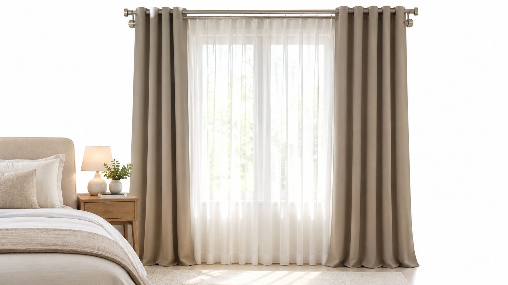 A bright bedroom interior featuring elegant beige blackout curtains and sheer drapes on a metal rod.