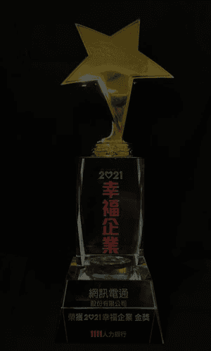 A serene outdoor lounge area with two chairs surrounded by lush greenery and natural light streaming in.