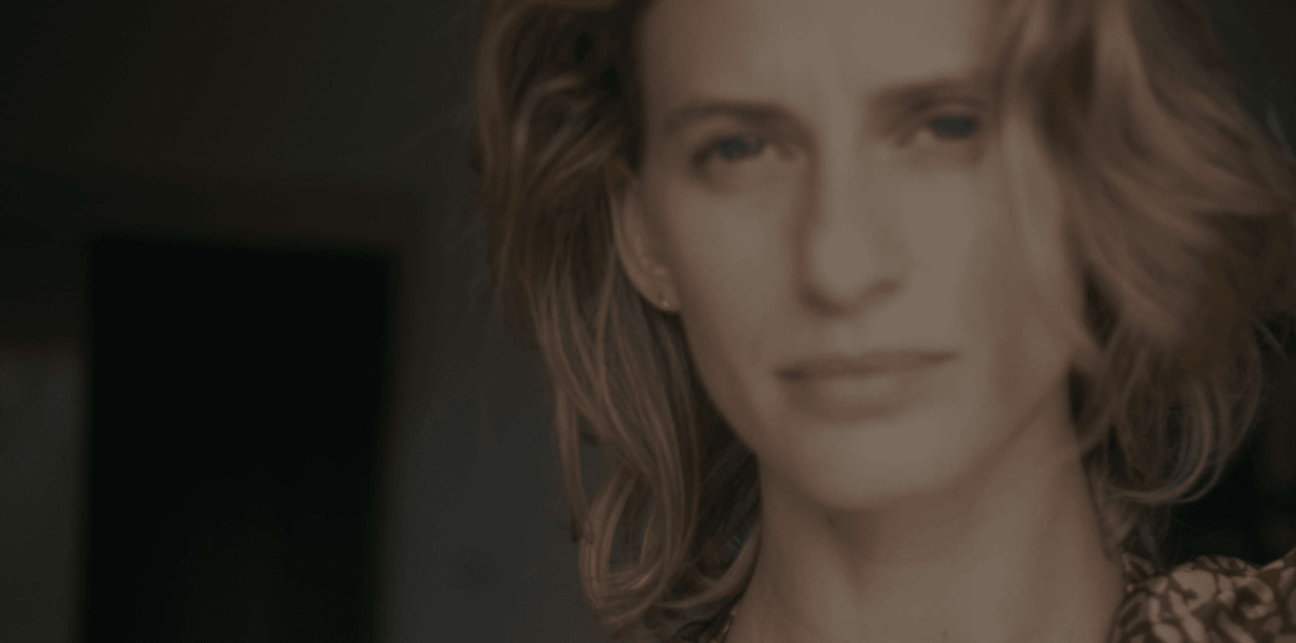 Close-up of an eye with creative makeup and white feathers.