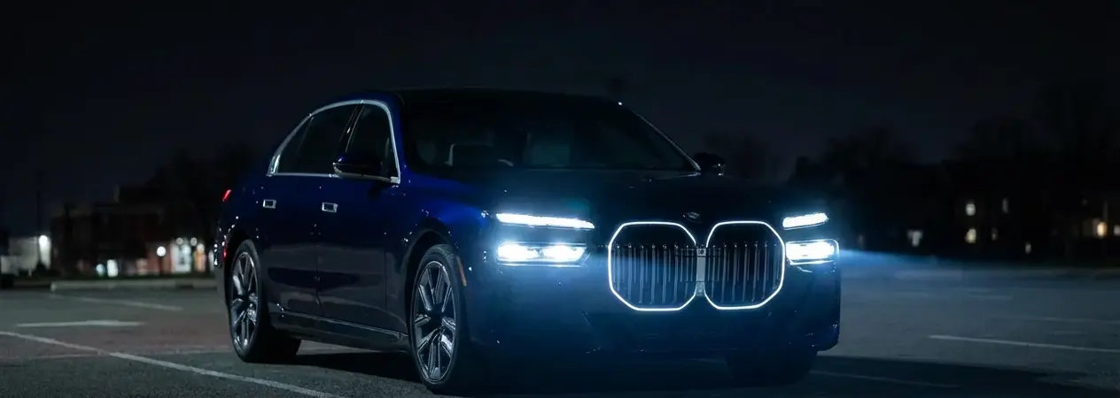 BMW car parked at night with headlight turned on