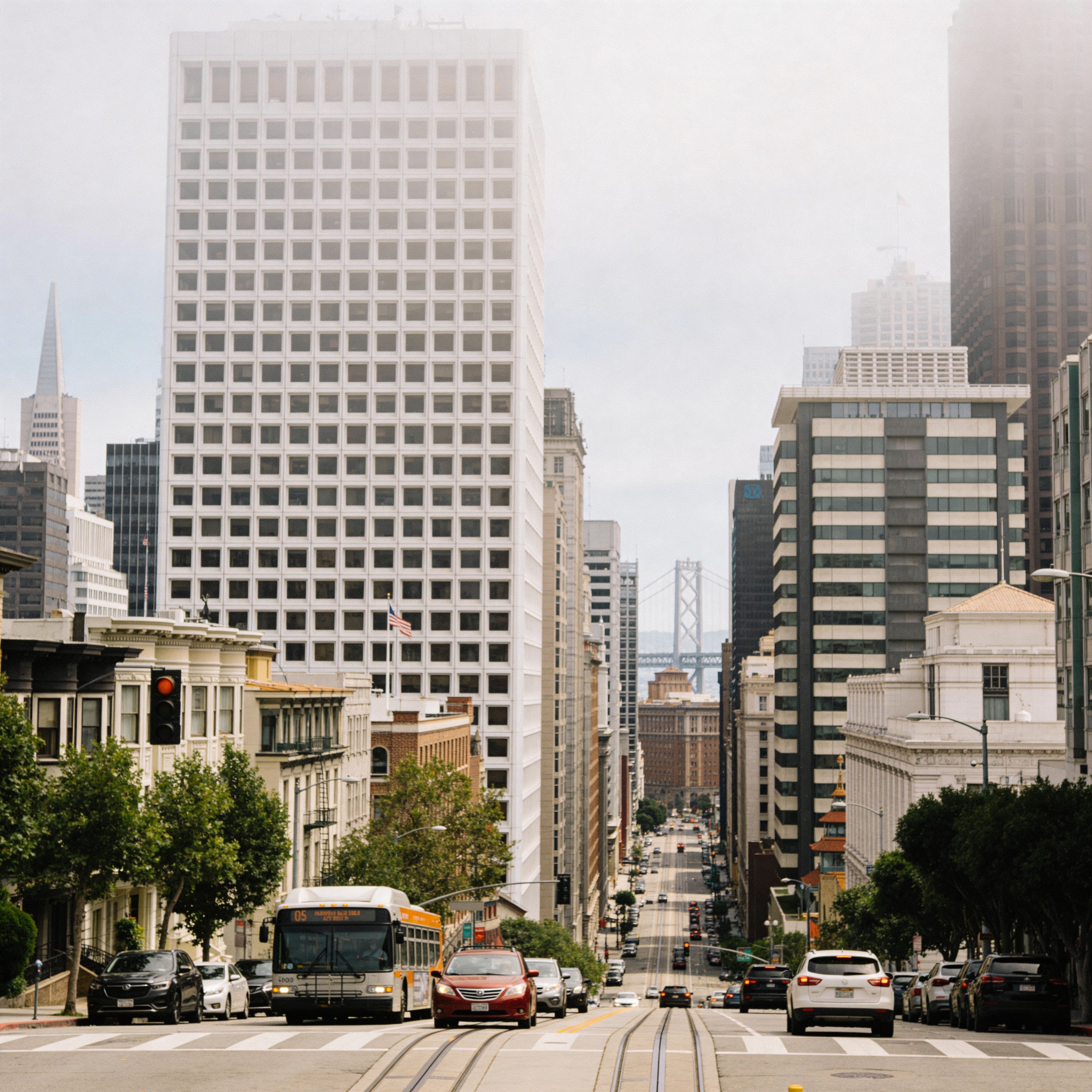 Downtown city street with high-rise office buildings, traffic, and urban skyline in San Francisco