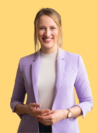 Close-up of a dark green leaf showing its textured surface and central vein against a muted background.
