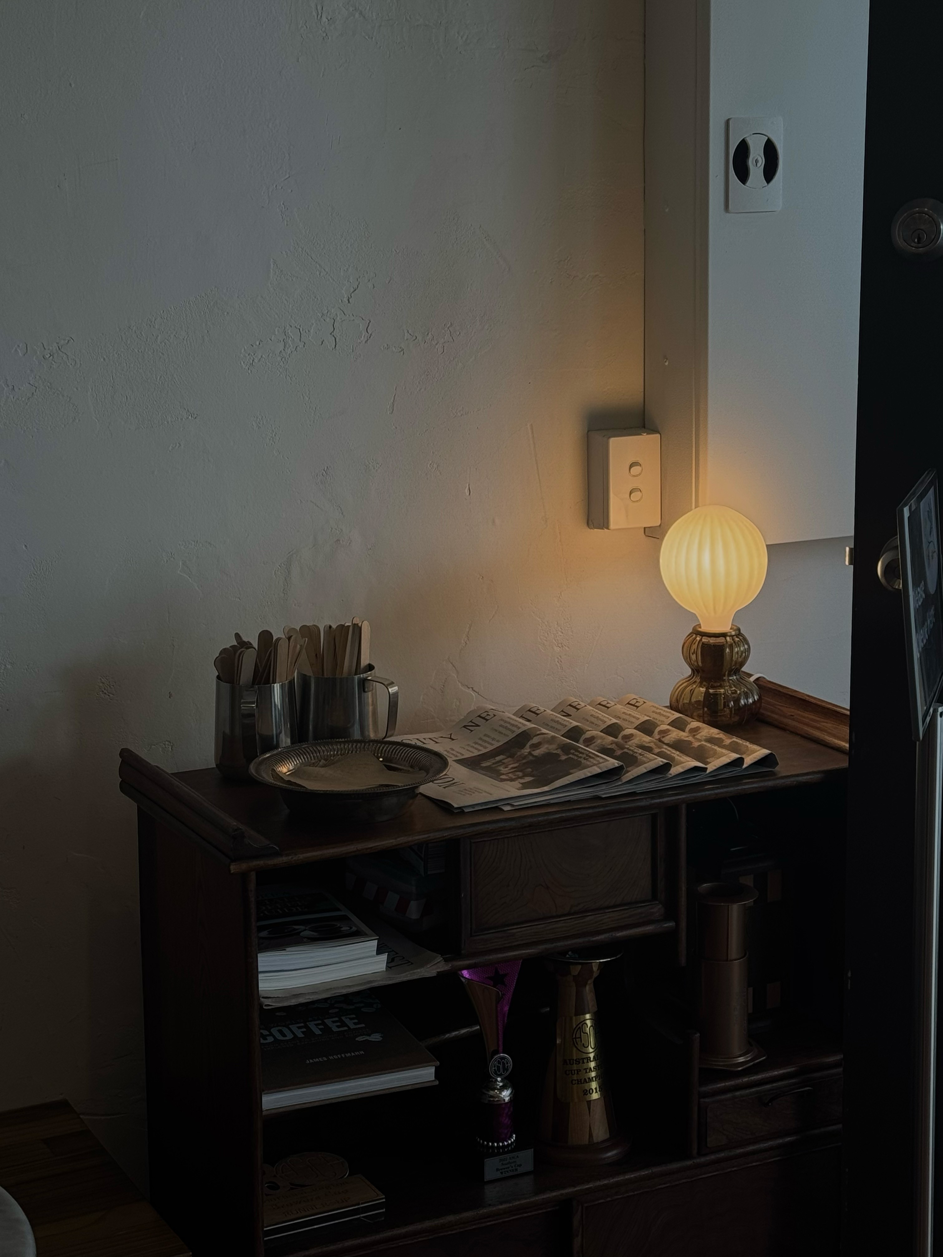 Aesthetic shelf with newspaper and lamp