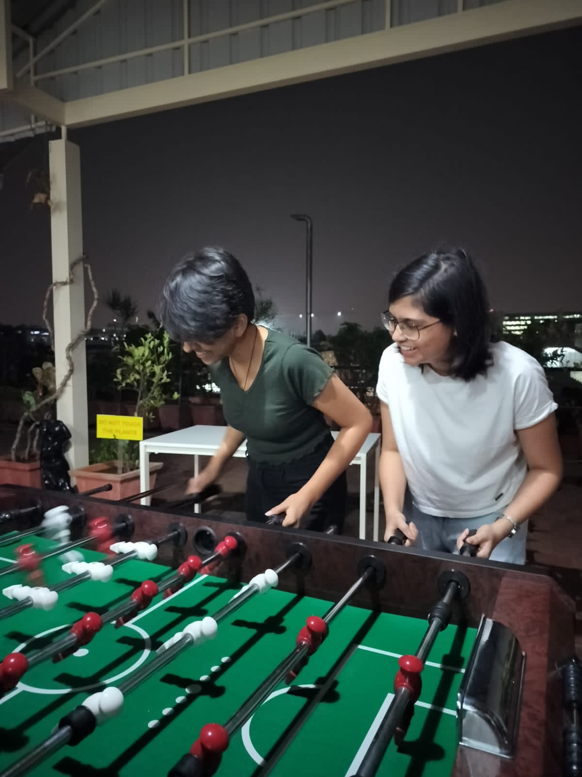 Two people playing Foosball