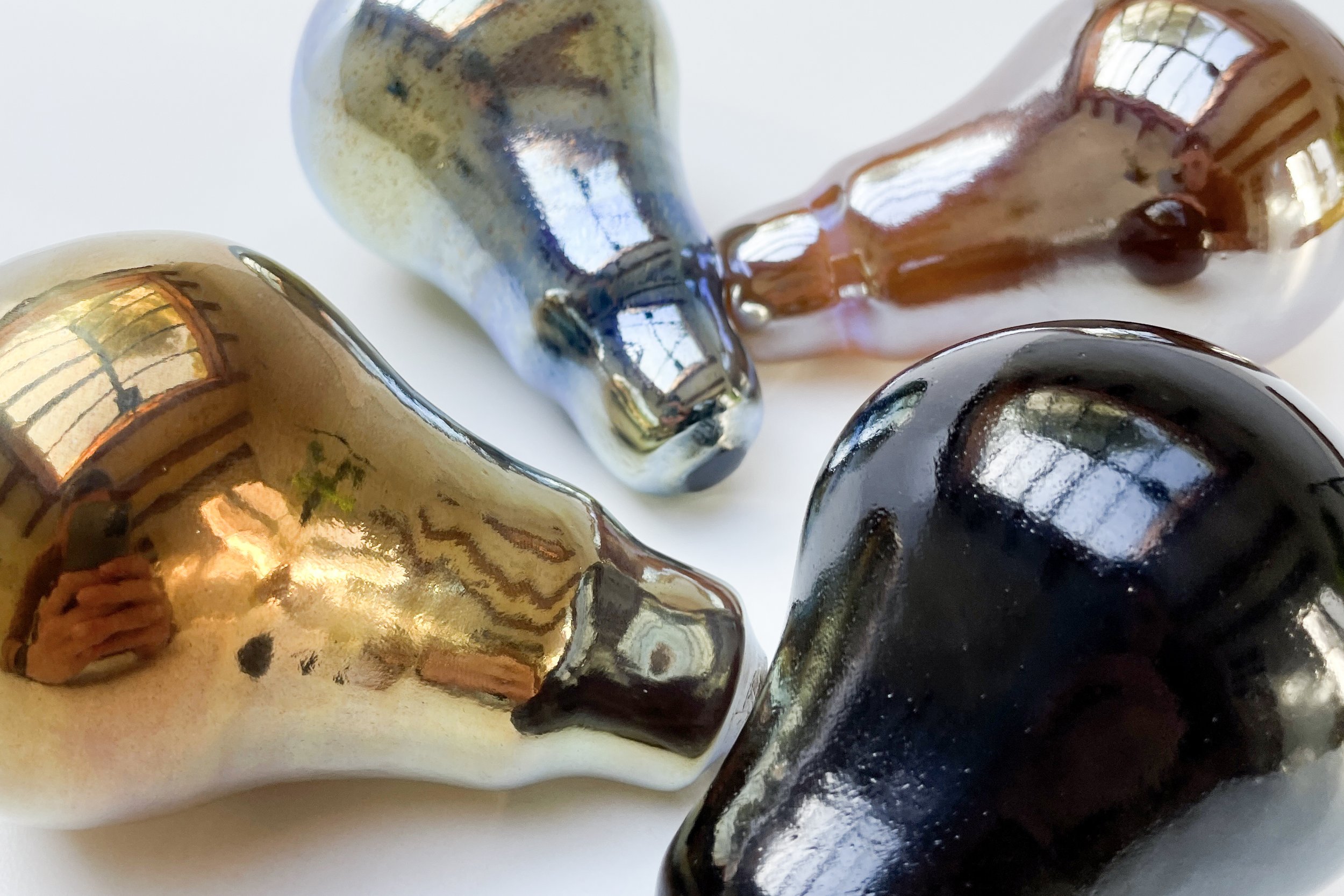 Image of various glass lamp awards in black, gold, silver and bronze