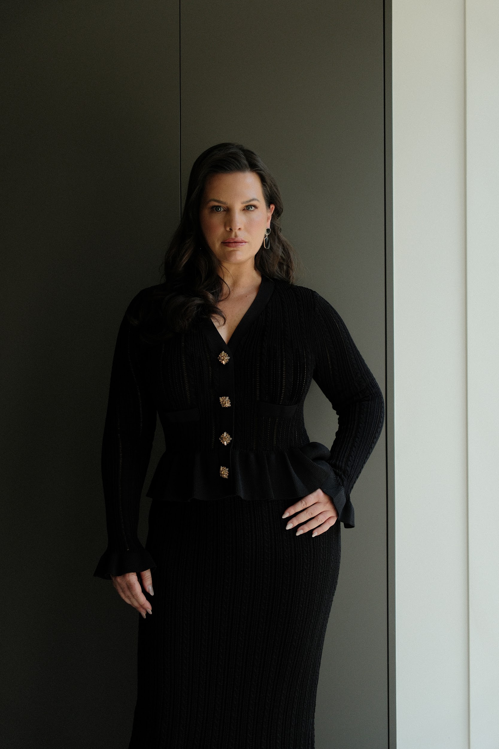 A woman sitting in a photo studio