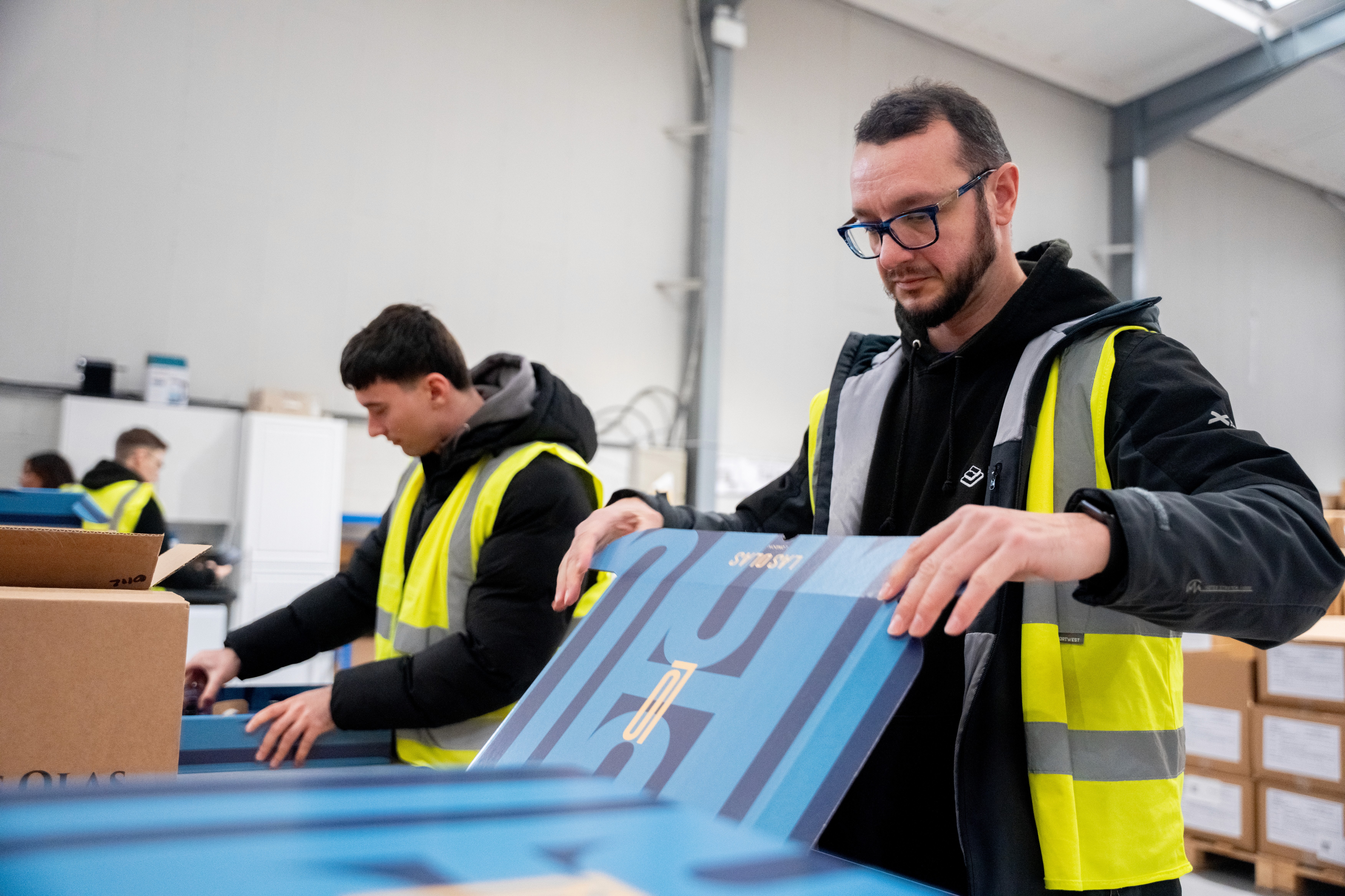 people putting together kitted bundles