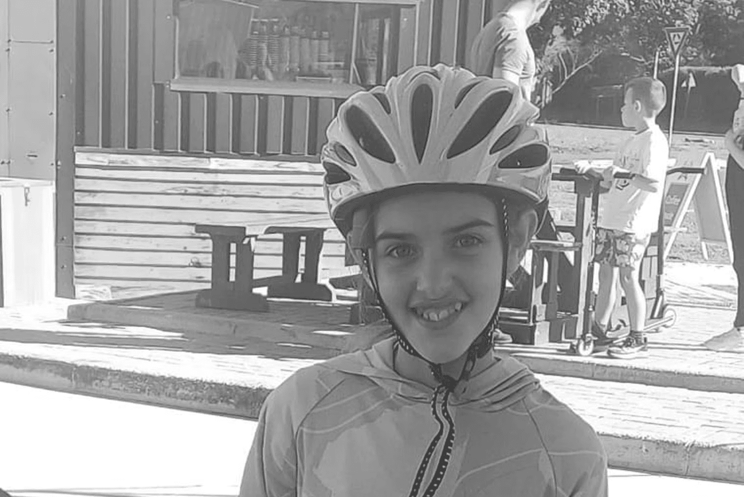 A fast black sports car races down the highway.