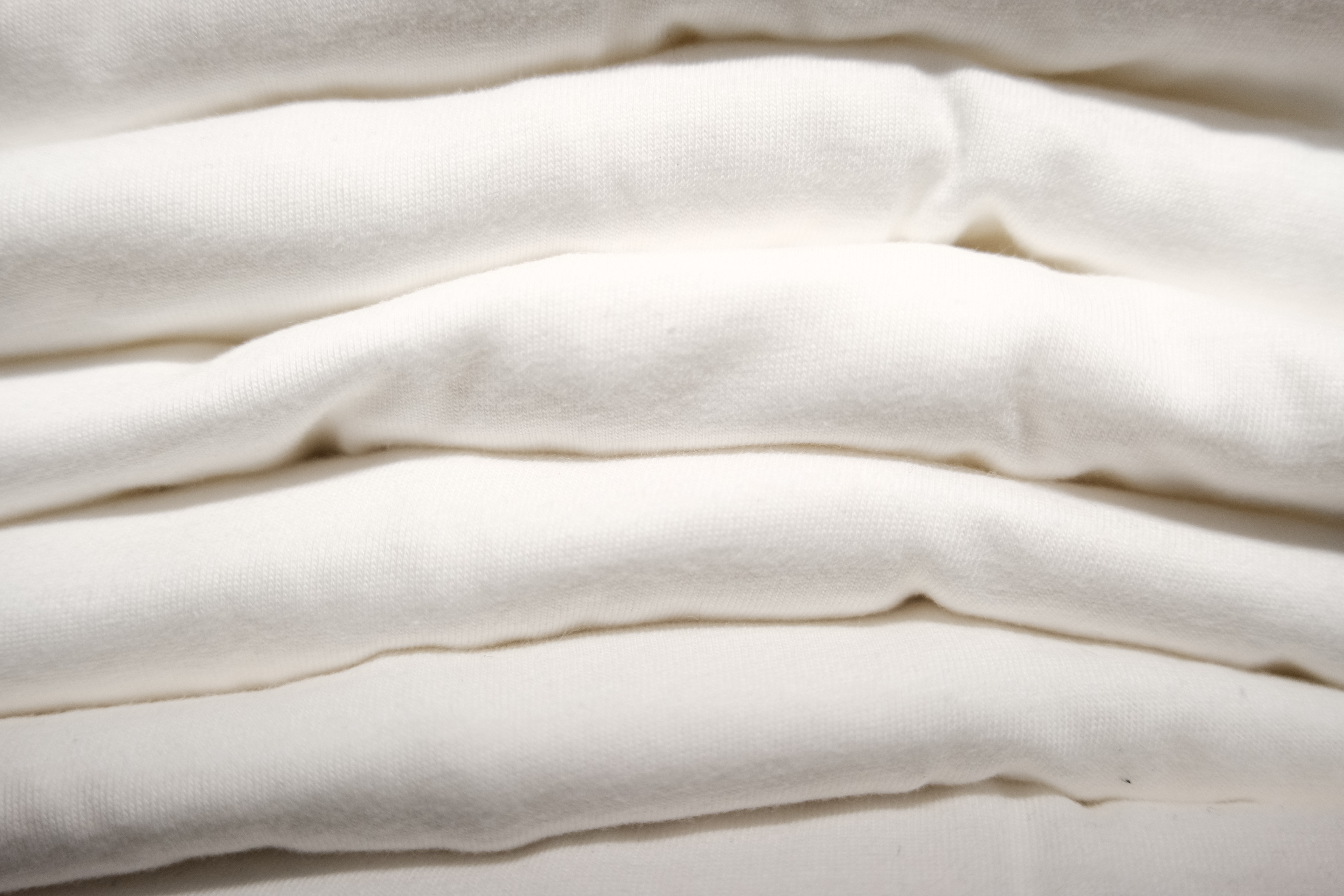 stack of white print ready t shirt