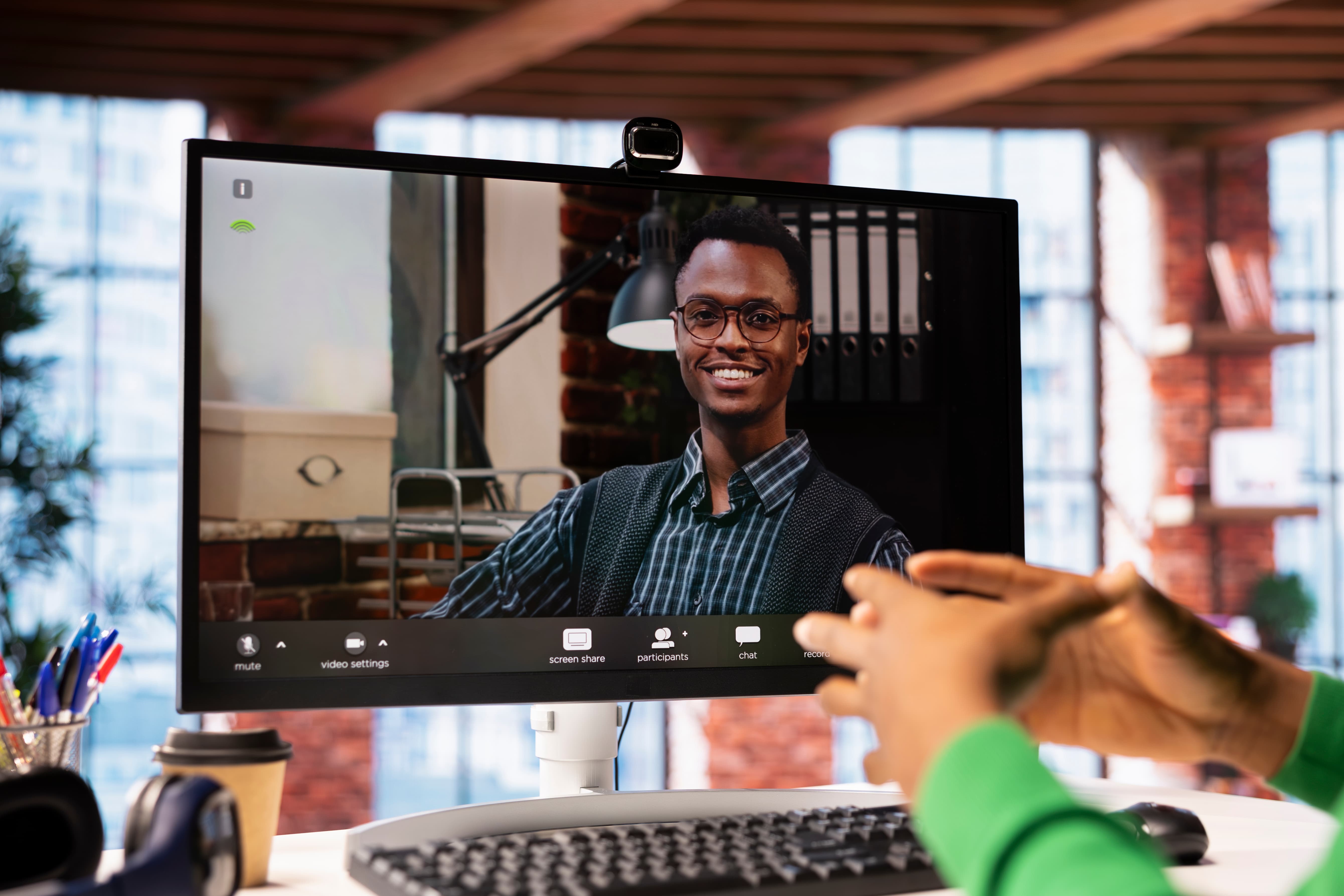 man engaging with real estate agent via video call