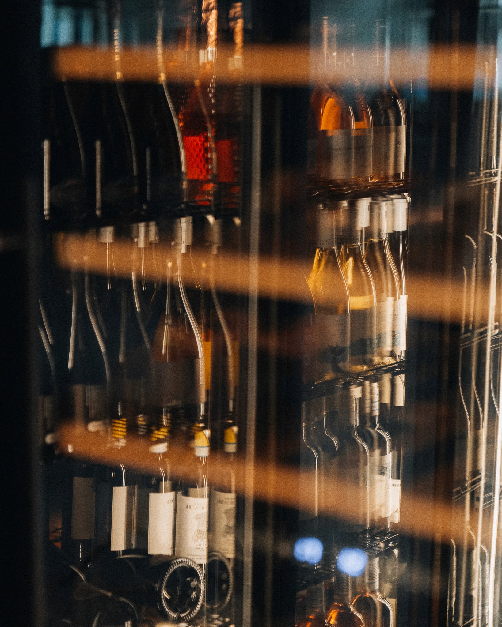 terrace in a small harbour with umbrellas, boats and tables