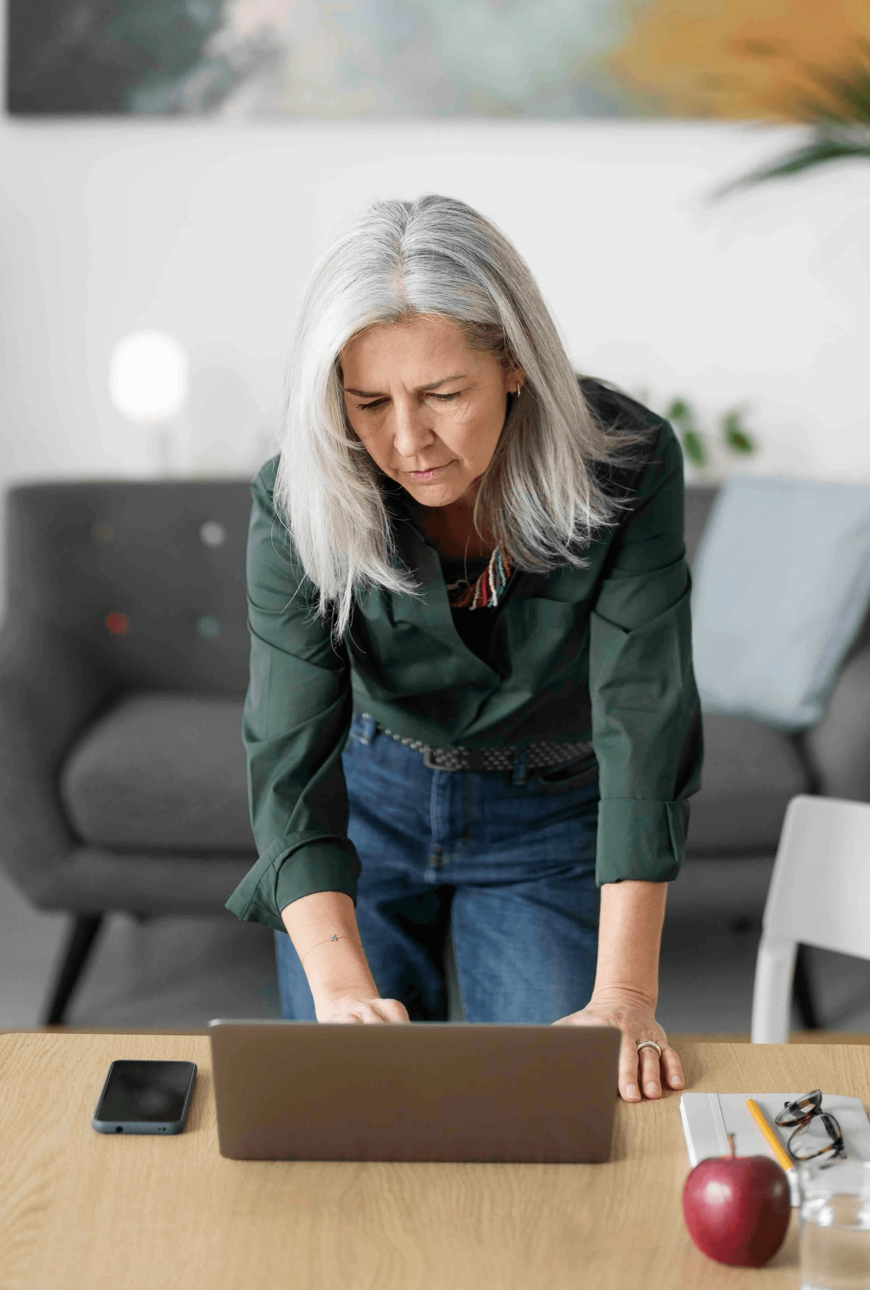 Woman holding phone looking at camera