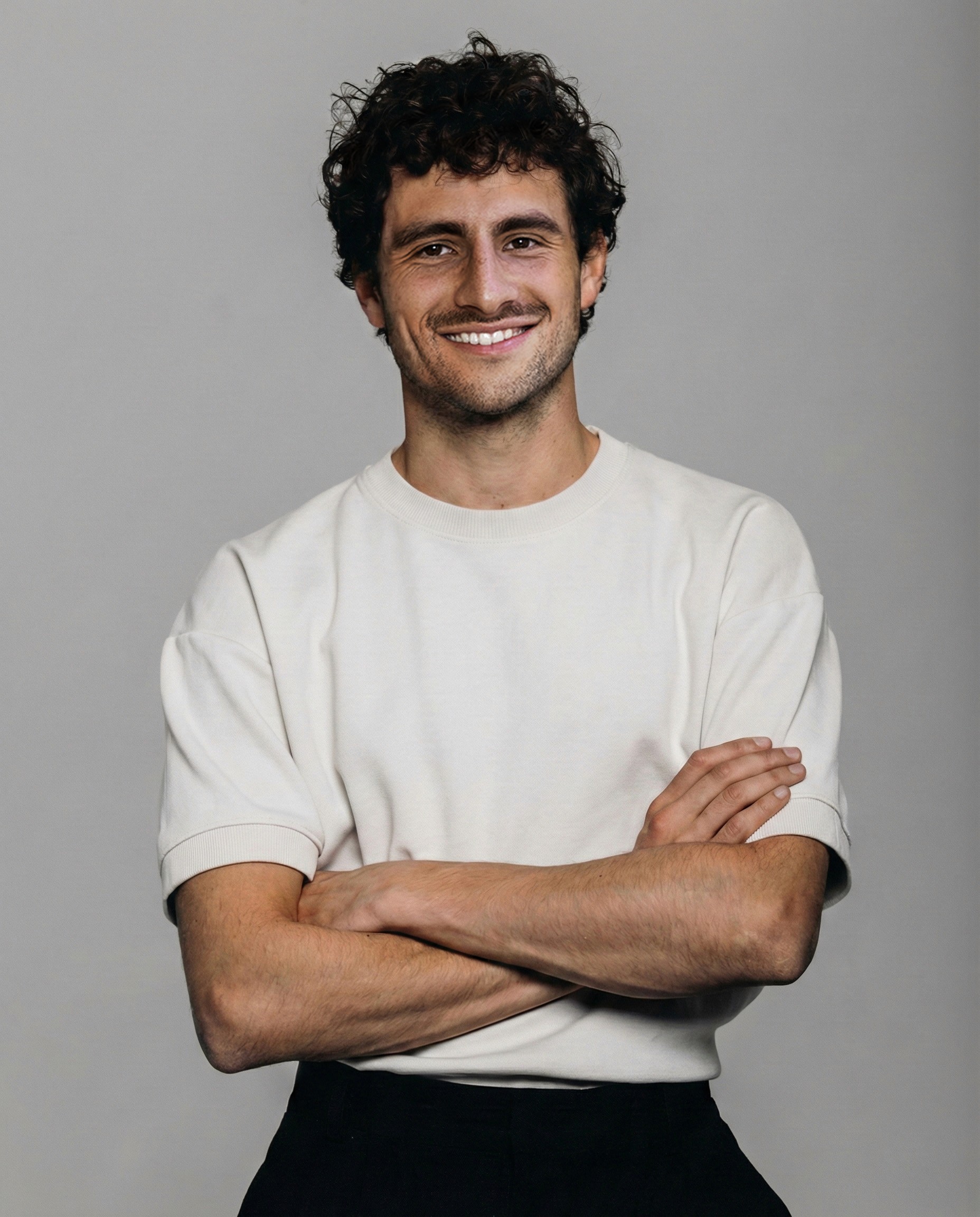 A view of a studio interior with modern decor, featuring large windows that offer a glimpse of lush greenery outside