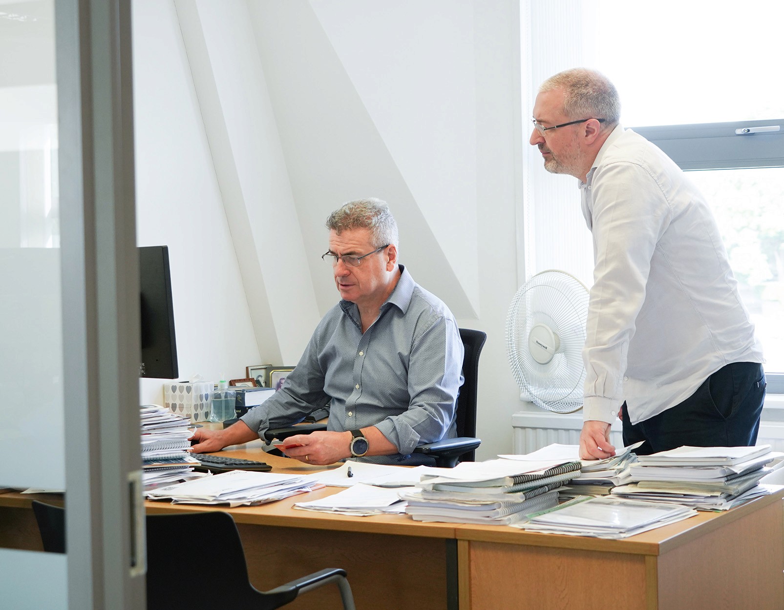 Hughes Price Walker actuarial team reviewing pension scheme funding and valuation documents.