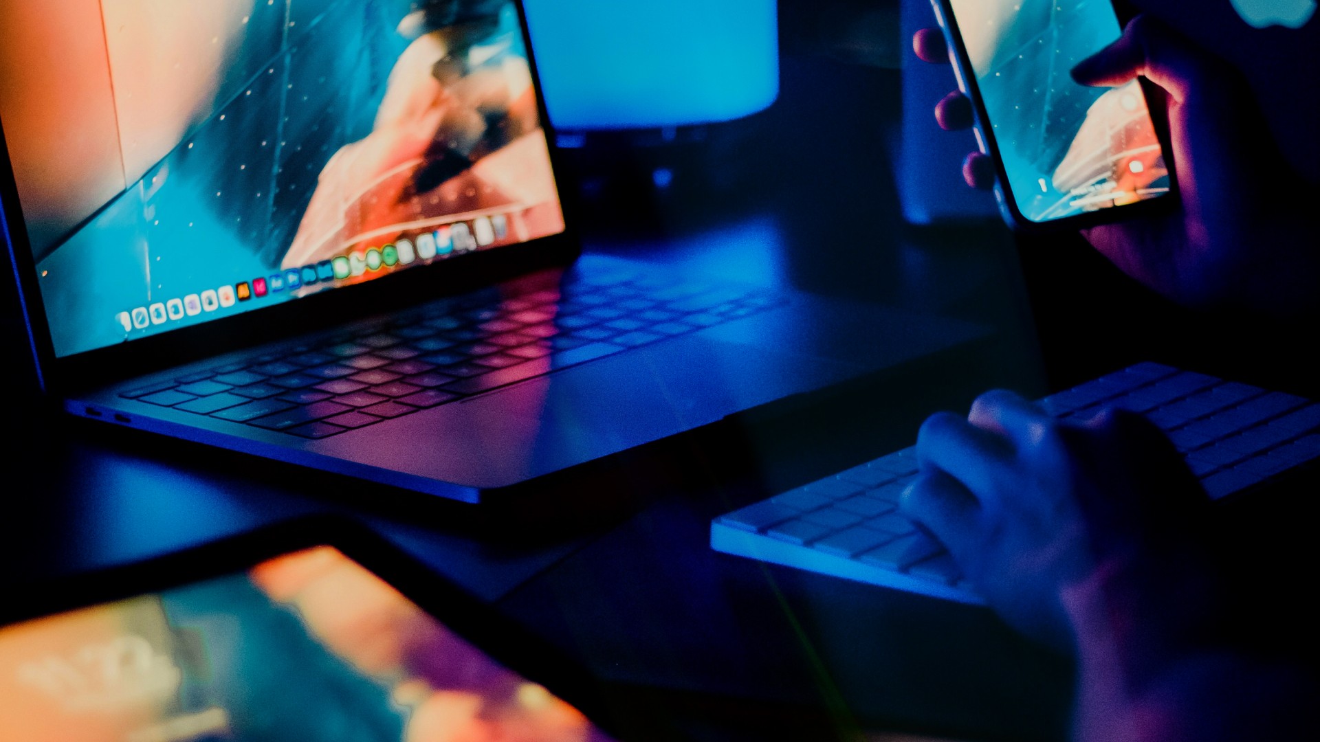 Close up of a laptop and hands typing at a keyboard