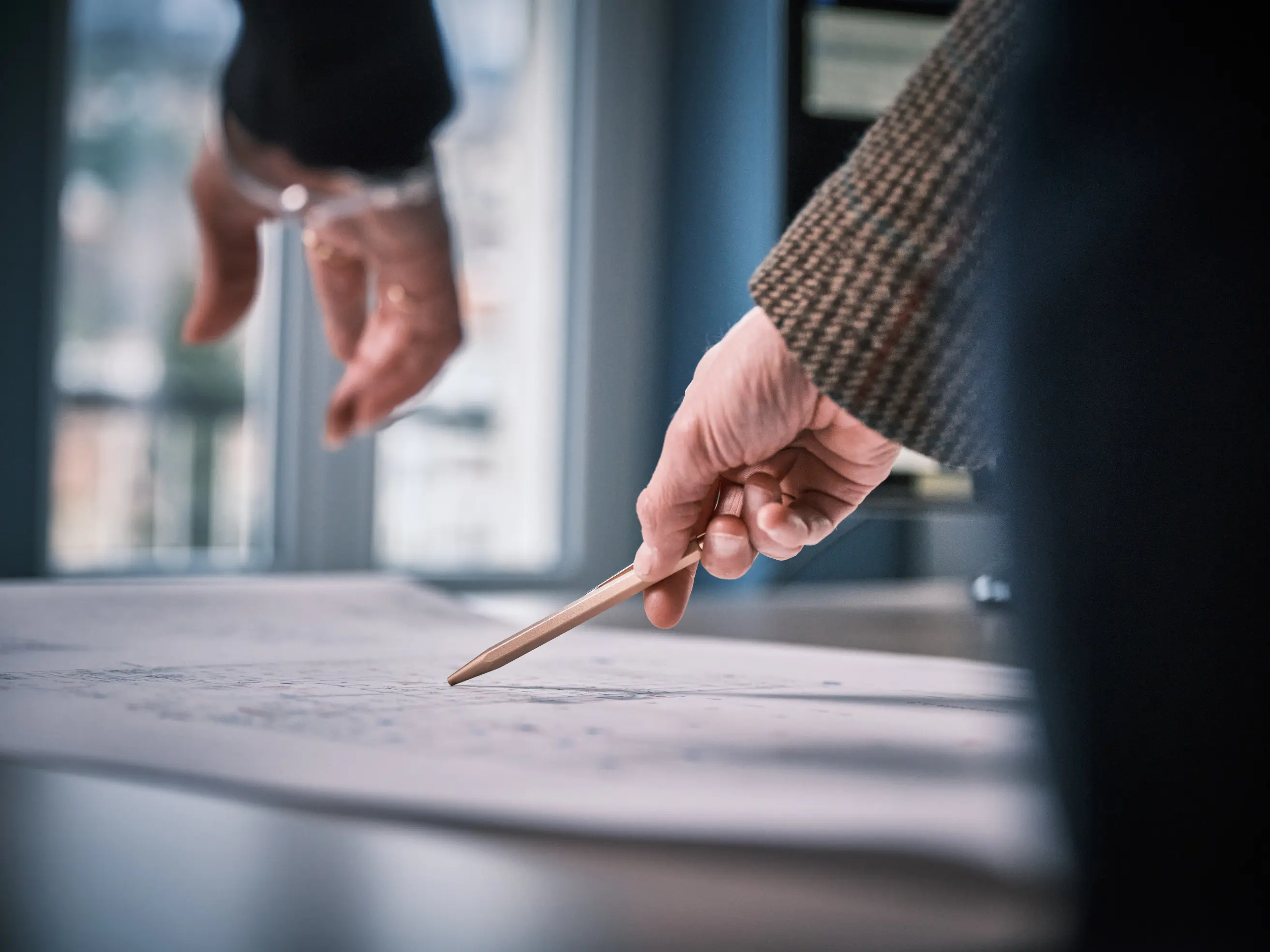 Sleek curved building with expansive glass windows, reflecting the sky and cityscape.