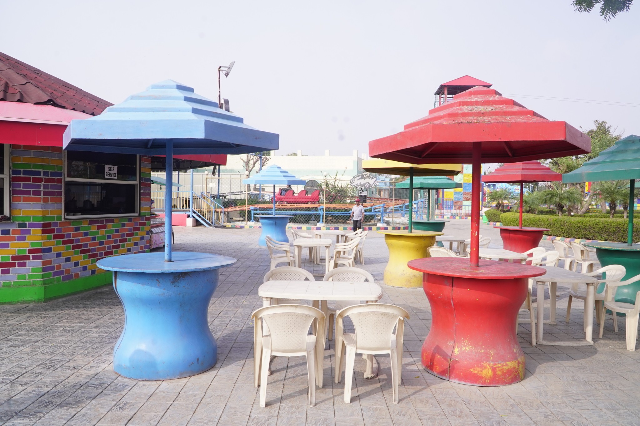 Modern orange lounge chair beside white coffee table.