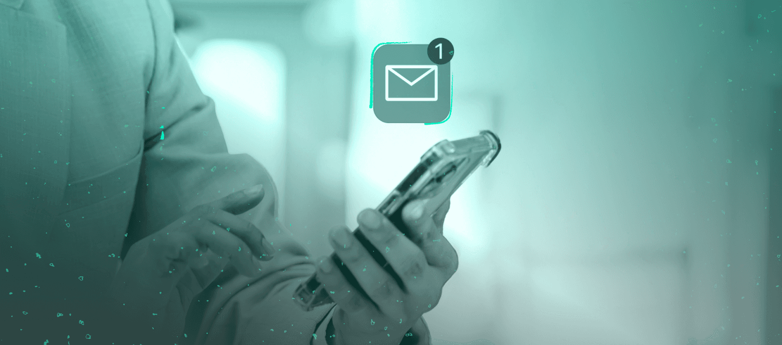 Person holding a smartphone with a new email notification icon, representing B2B newsletter engagement and the challenge of maintaining subscriber attention over time.